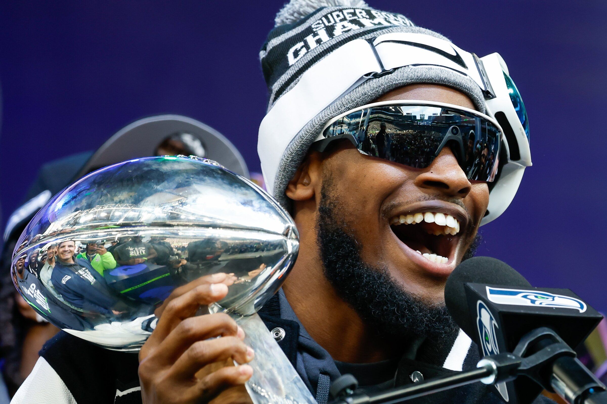 Seahawks cornerback Devon Witherspoon holds the Lombardi Trophy during the team’s victory celebration before the Super Bowl parade in February. (Jennifer Buchanan / The Seattle Times)