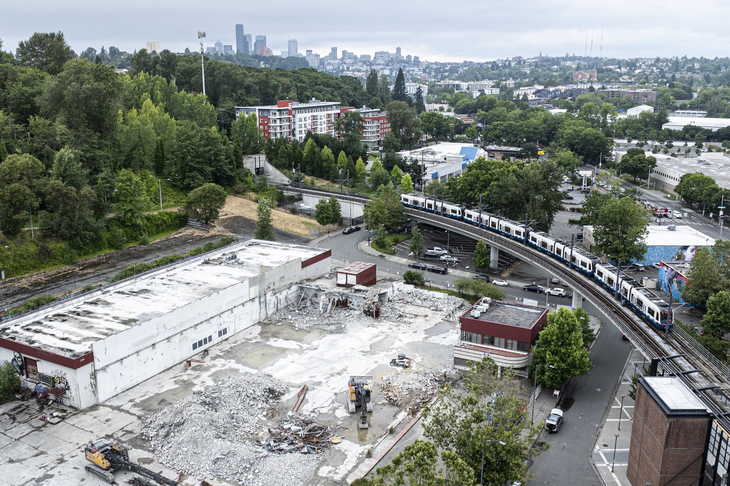 The Mount Baker Station looms over the demolition of an old University of Washington laundry facility, part of the prep work for construction of hundreds of affordable apartments. (Kevin Clark / The Seattle Times)
