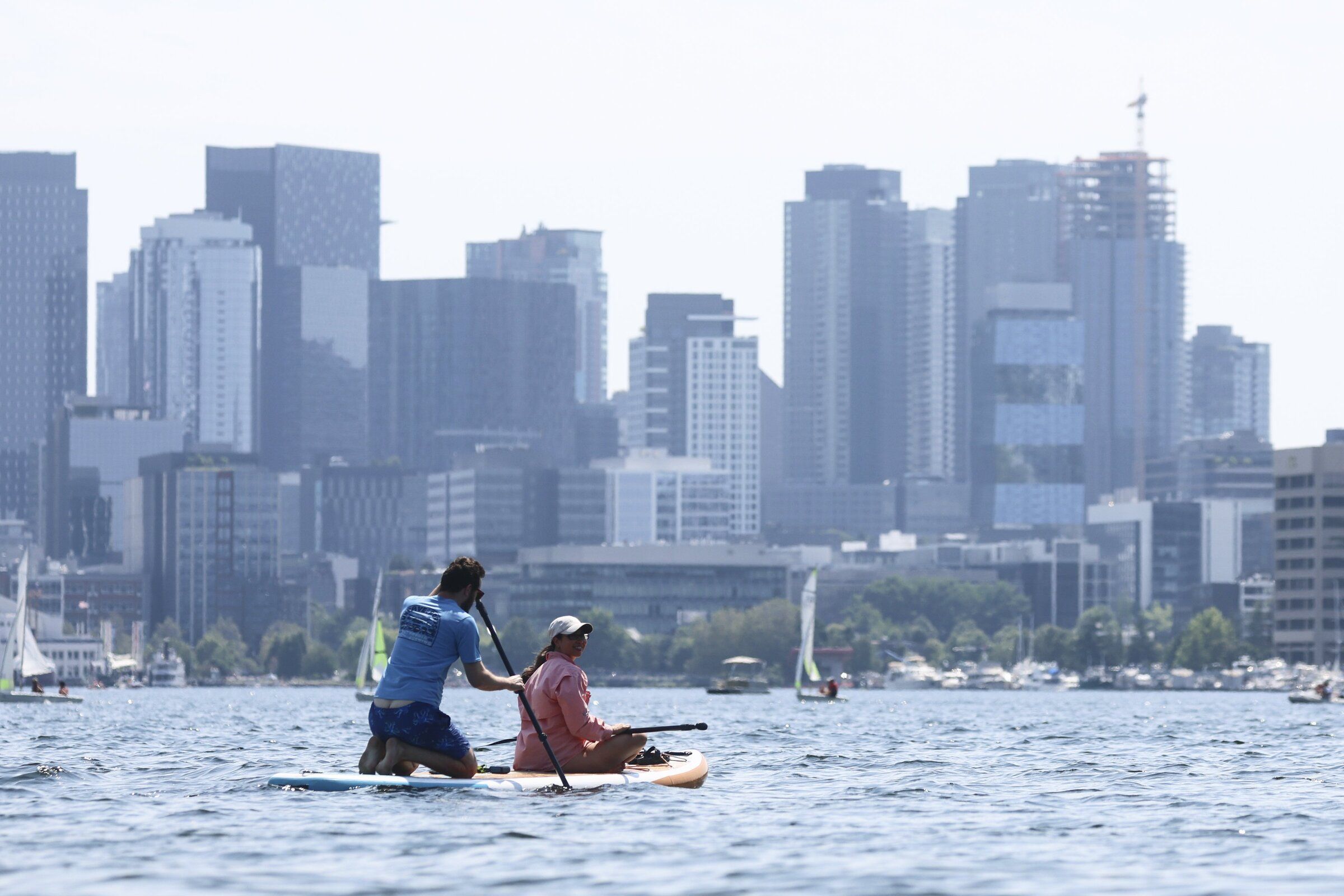 Paddle boarders on the waters of Lake Union on Tuesday afternoon from Gas Works Park in Seattle. (Kevin Clark / The Seattle Times)