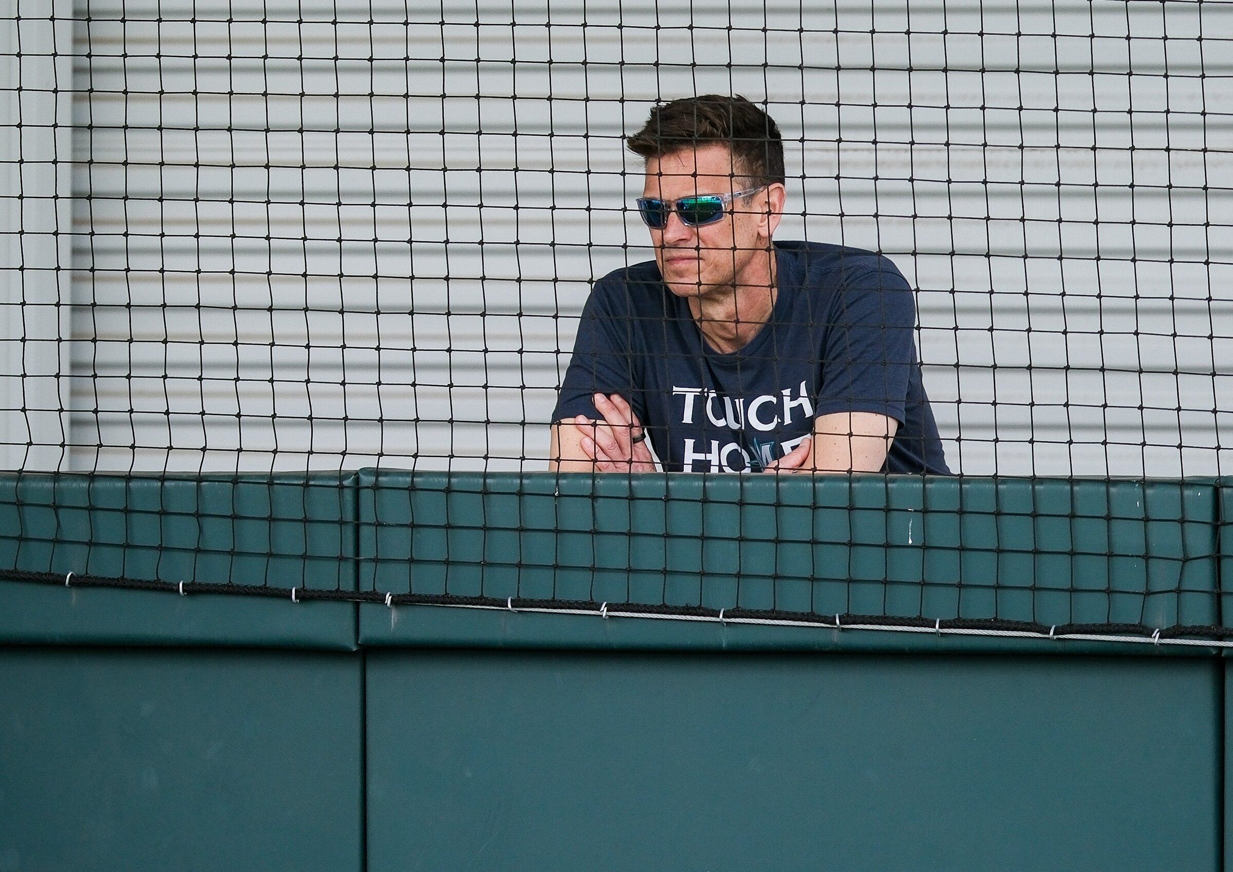 Jerry Dipoto watches a bullpen session during spring training in Peoria, Ariz., in February. (Dean Rutz / The Seattle Times)