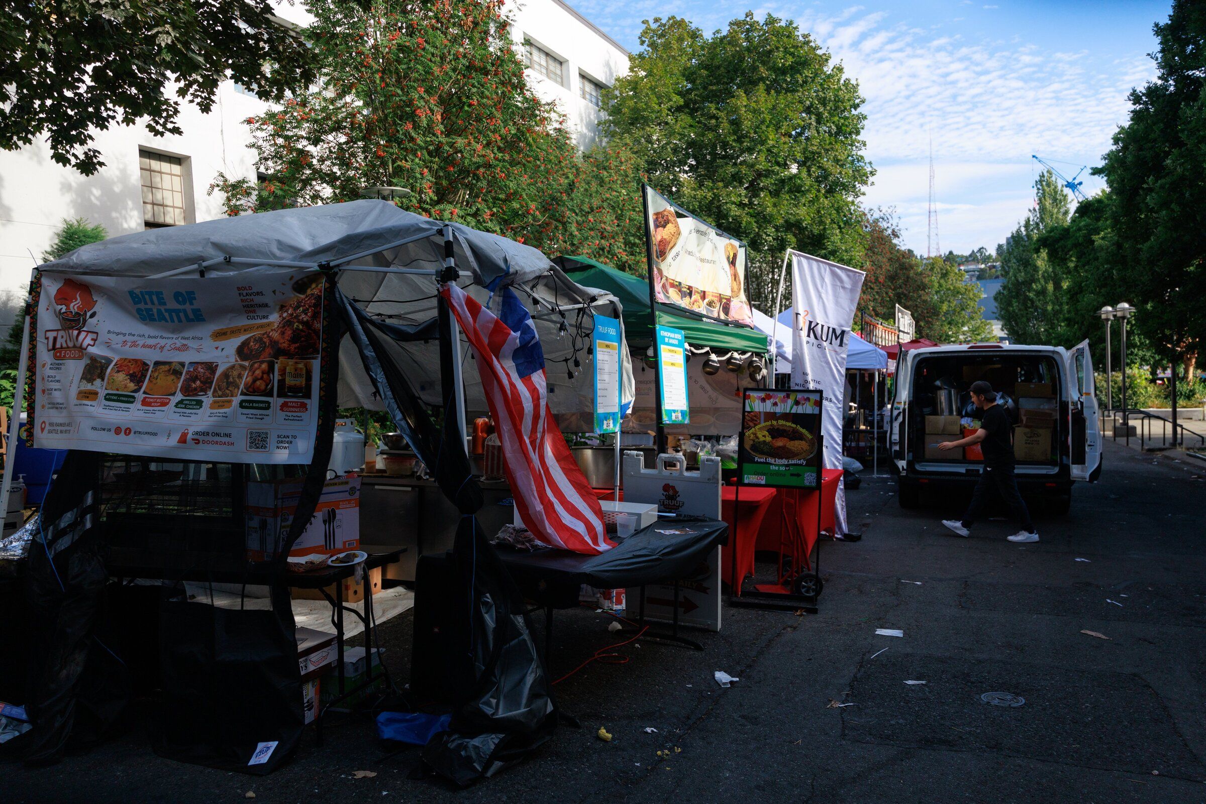 A vendor packs up their food stand at the Seattle Center on Monday after a shooting at the Bite of Seattle food festival the day before that killed three people. (Erika Schultz / The Seattle Times)