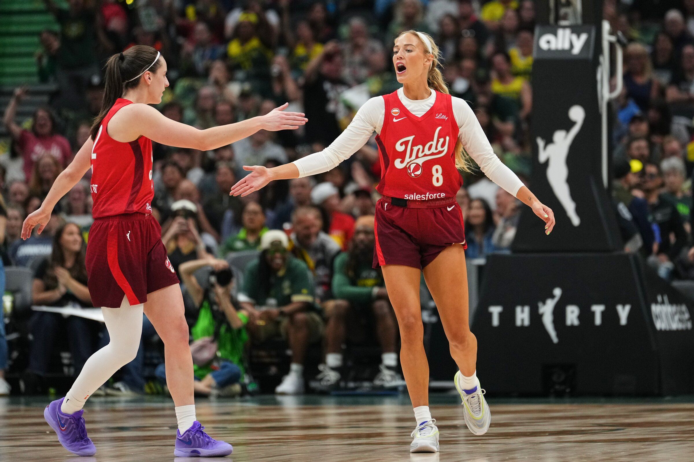 Indiana Fever guard Caitlin Clark, left, celebrates with guard Sophie Cunningham after Cunningham made a basket against the Seattle Storm, Tuesday, July 28, 2026, in Seattle. (Lindsey Wasson / AP)