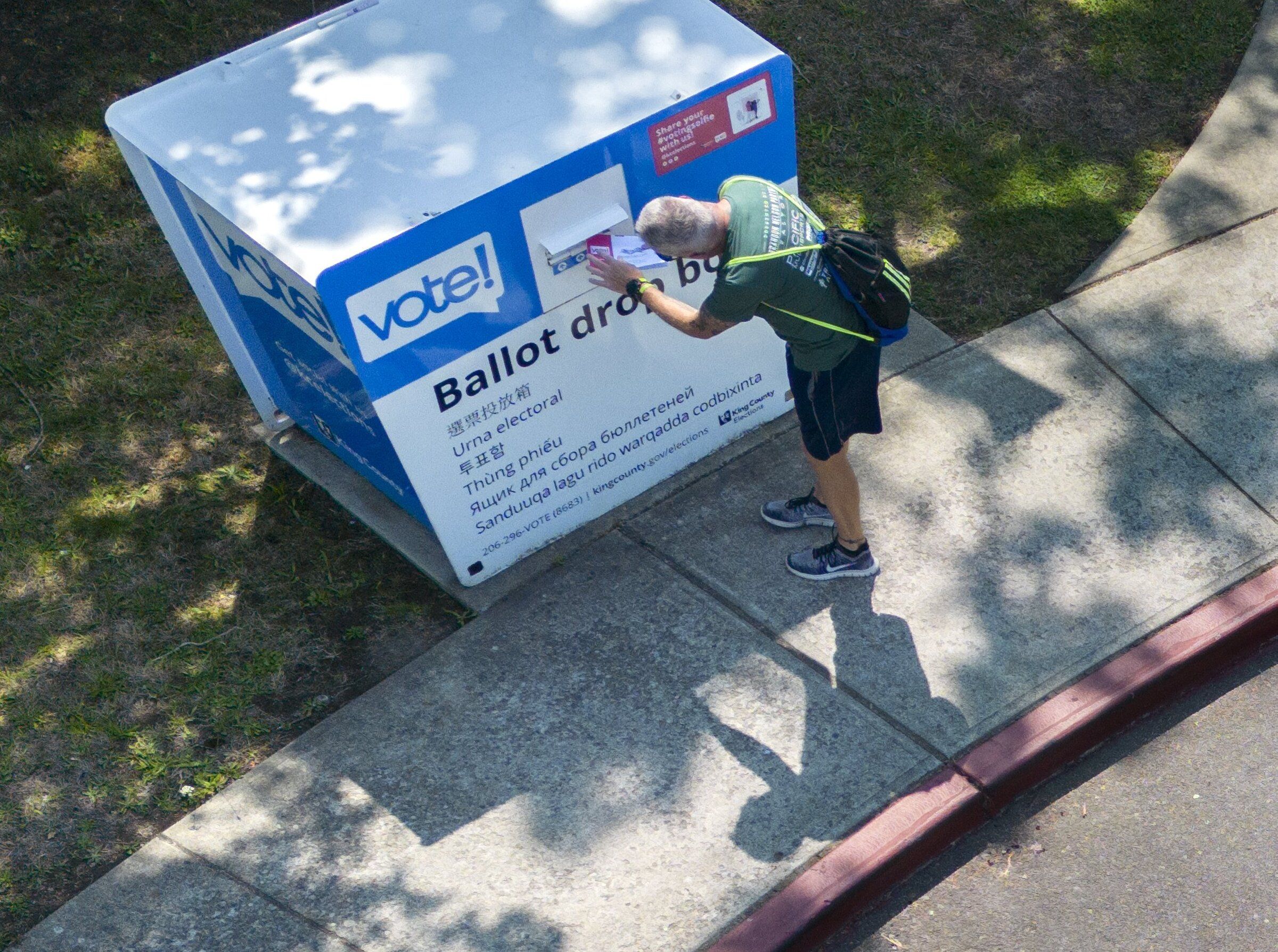 A voter drops off a ballot at the drop box at Rainier Beach Community Center in Seattle. (Ellen M. Banner / The Seattle Times, 2025)