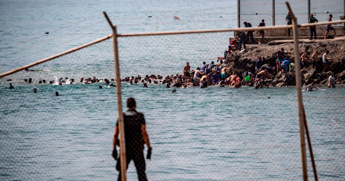 Spain’s enclave Ceuta raises alarm as thousands cross border from Morocco
