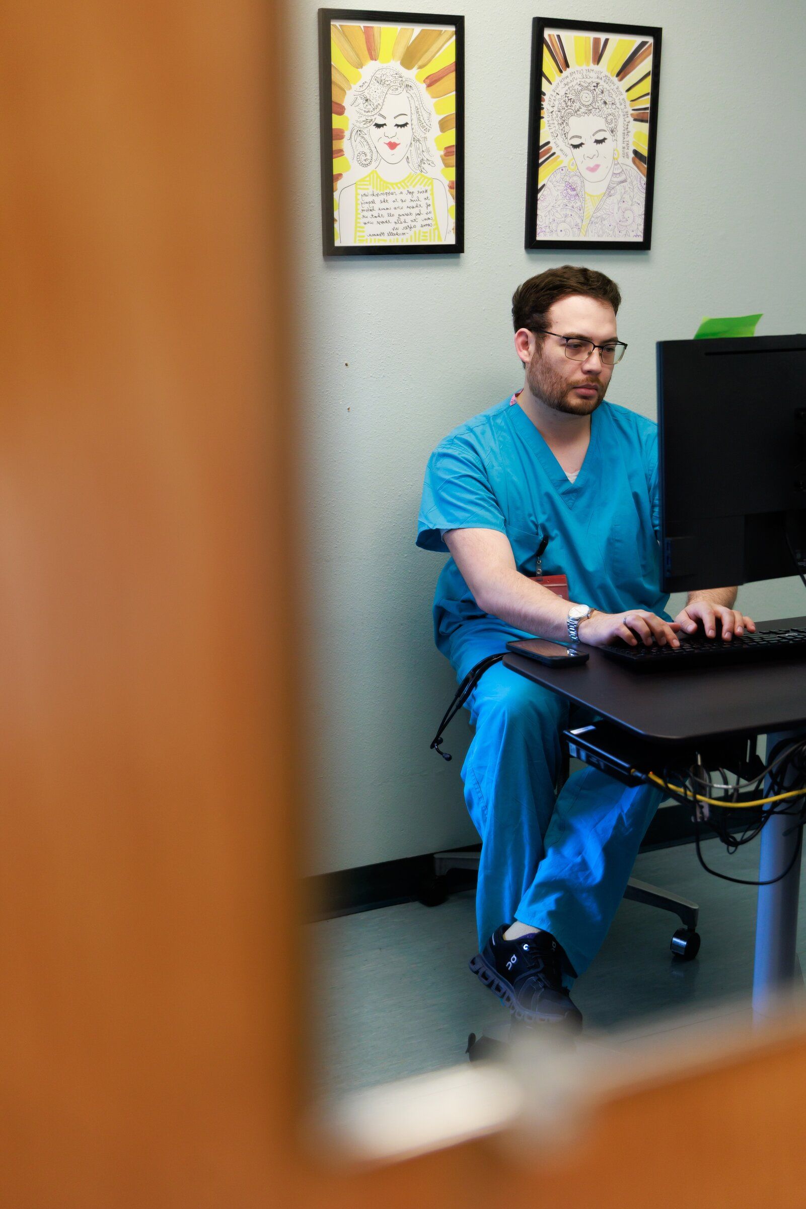 Dr. Brian Sedeño sees a patient via telemedicine at the Carolyn Downs Family Medical Center in Seattle’s Central District. Sedeño is a third-year family medicine resident at Providence Swedish. (Erika Schultz / The Seattle Times)