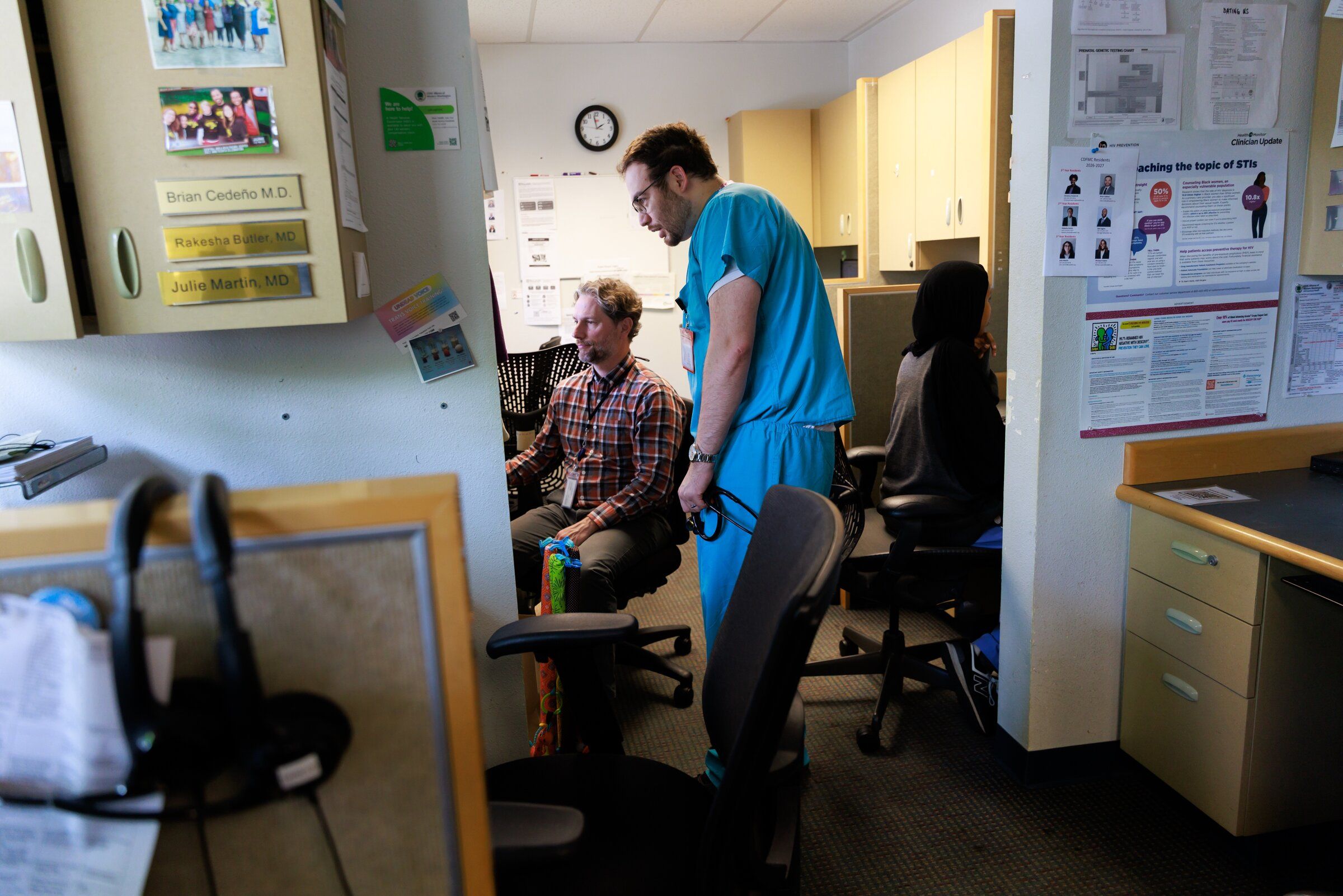 Dr. Brian Sedeño, right, speaks with Dr. Matt Logalbo, medical director of the Carolyn Downs Family Medical Center. (Erika Schultz / The Seattle Times)
