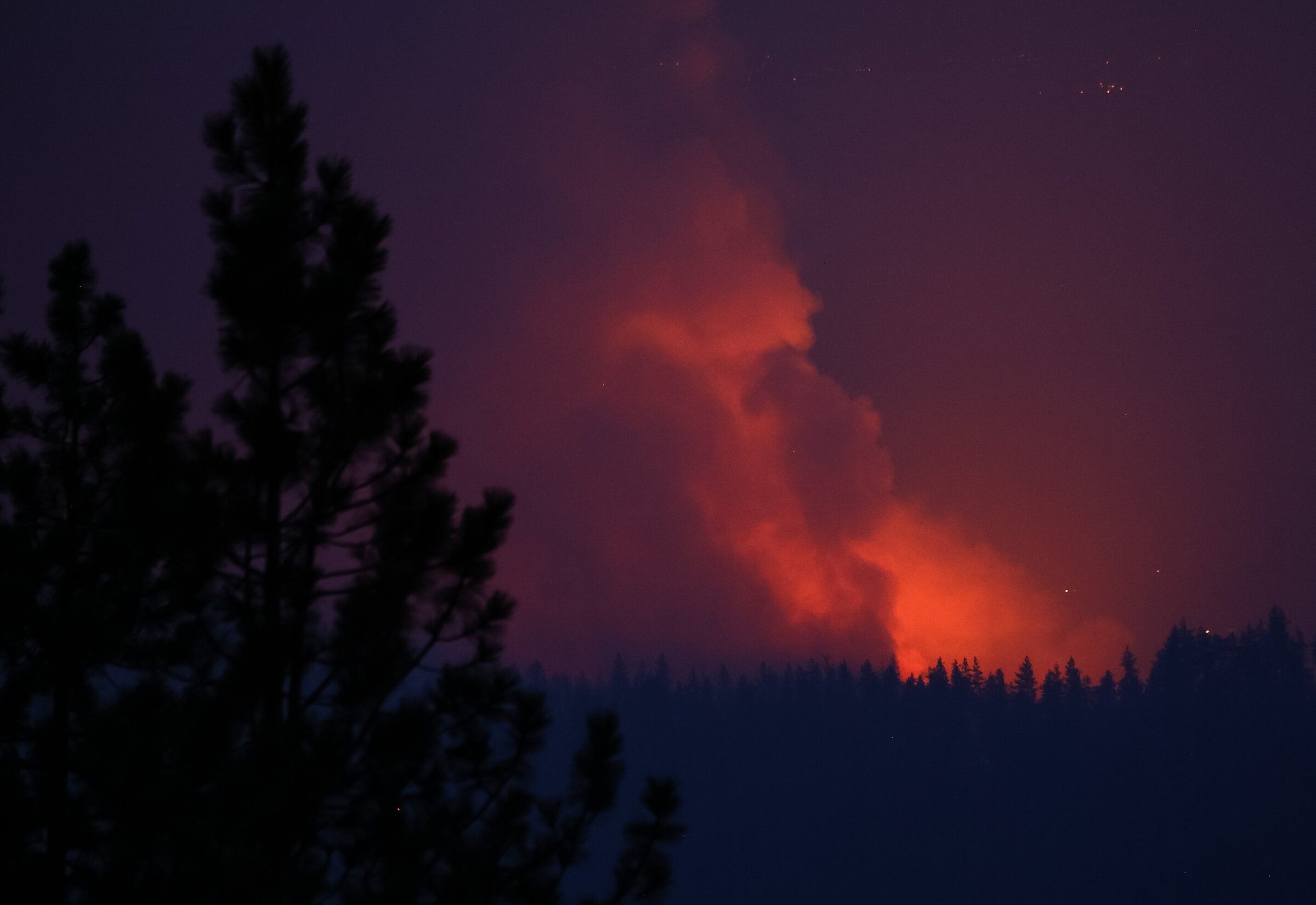 The Autumn Lane fire emits an orange glow on Monday near Spokane. (Nick Wagner / The Seattle Times)