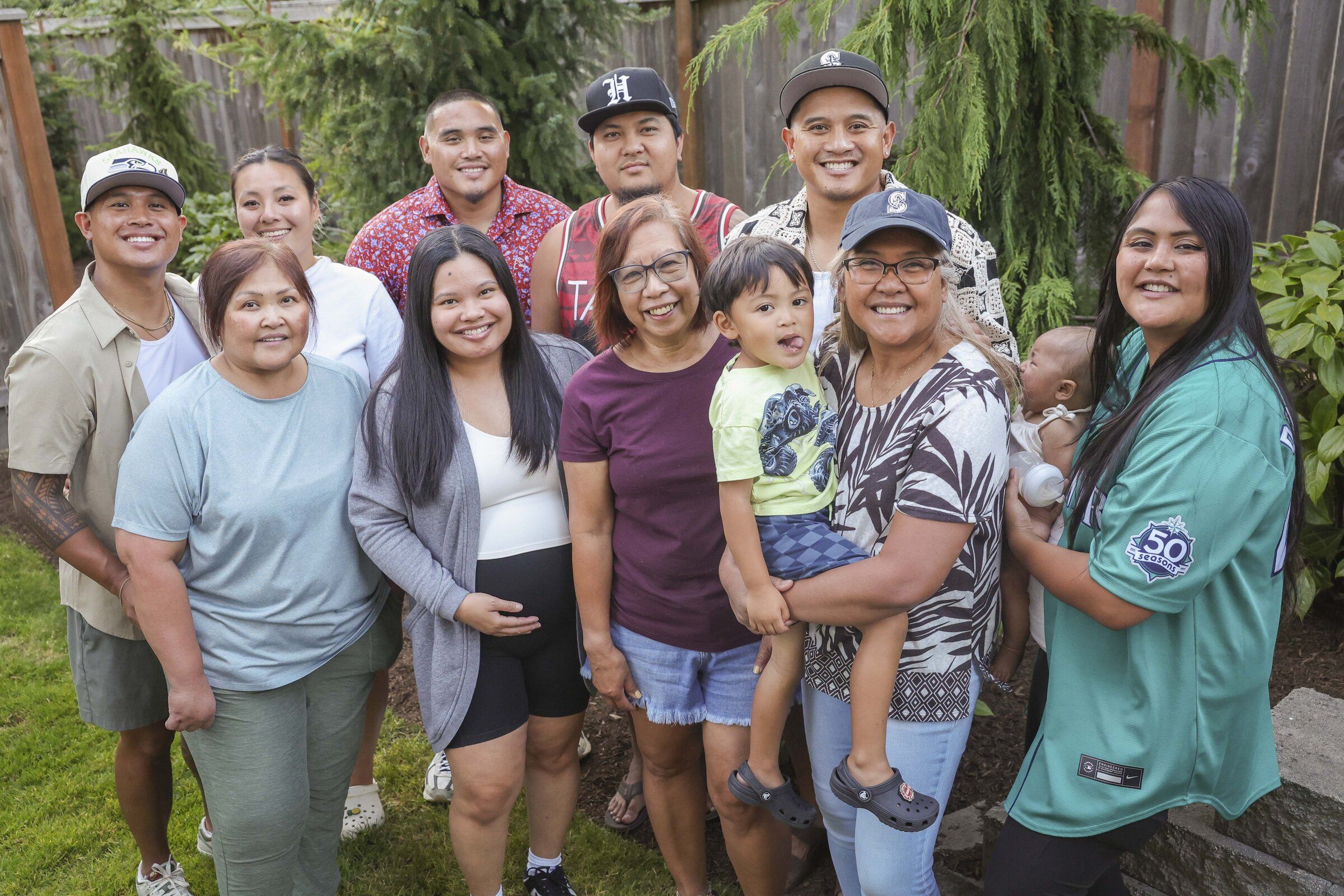 Lewelyn Dixon and members of her family at home last month. Deep in their hearts, Dixon and her relatives still feel anxious that their citizenship could be taken away again. The Trump administration has launched unprecedented efforts to strip citizenship from those the federal government claims got citizenship unlawfully. (Ivy Seballo / The Seattle Times)