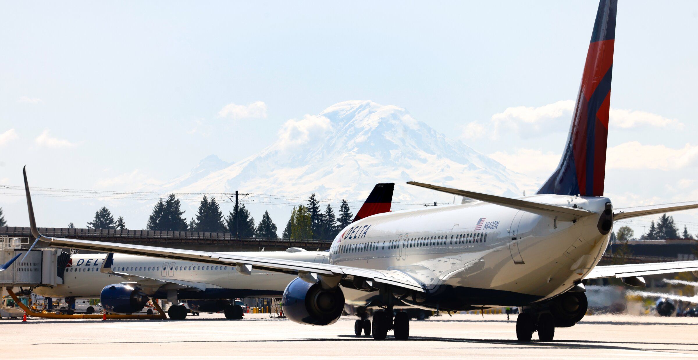 A Delta Airlines plane with Mount Rainier in the background at Seattle-Tacoma International Airport in April. (Karen Ducey / The Seattle Times)