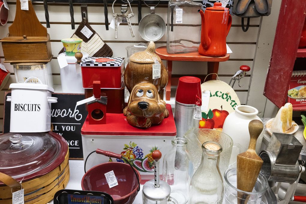 A cookie jar shaped like a dog with a comical gaze nicely anchors a display of kitchen items at the Antique Mall of West Seattle, Sunday, Aug. 2, 2026. (Ken Lambert / The Seattle Times)