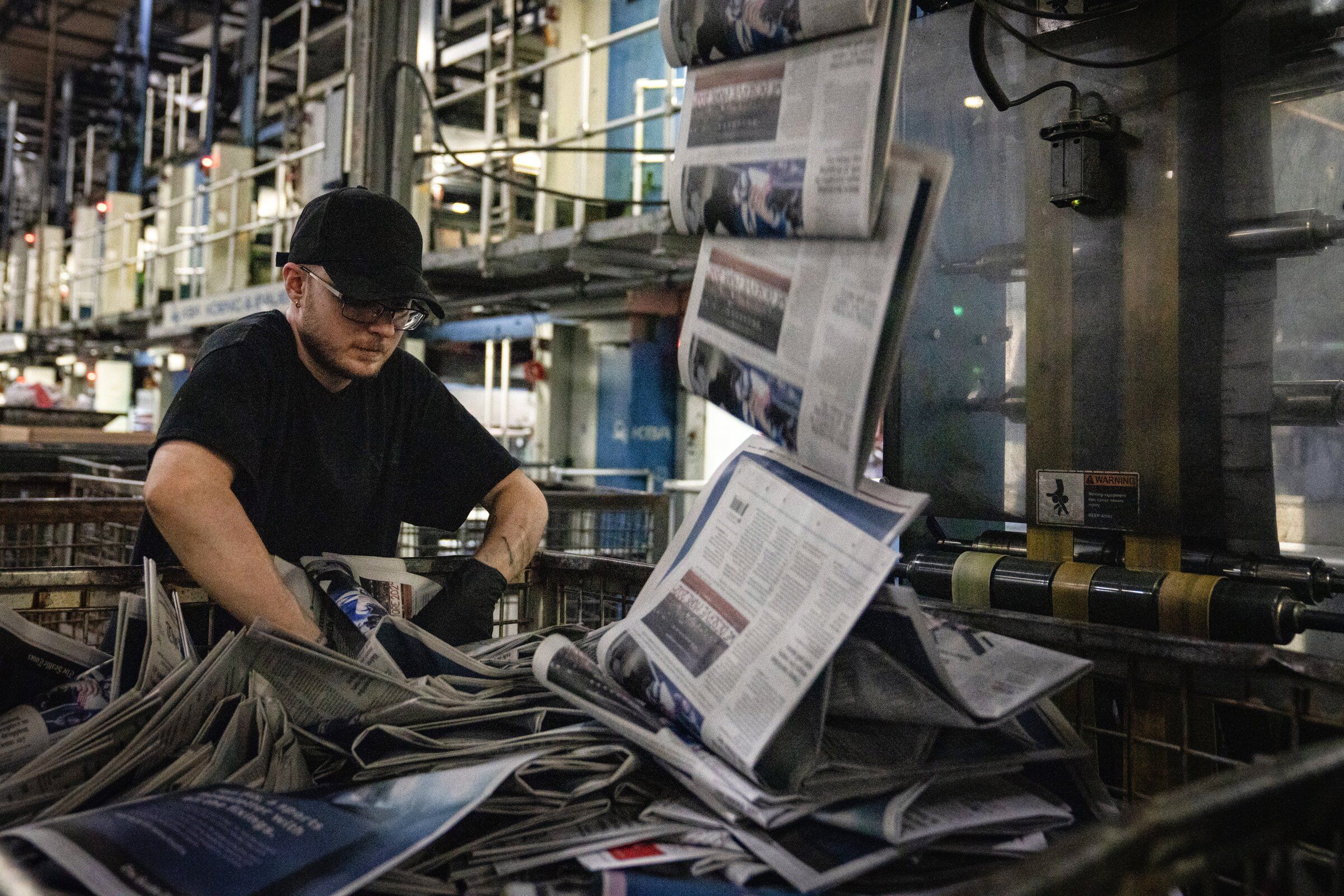 The Seattle Times comes off the press after fine adjustments are made by Times printing press workers at Rotary Offset Press in Kent. (Audrey Richardson / The Seattle Times, 2024)