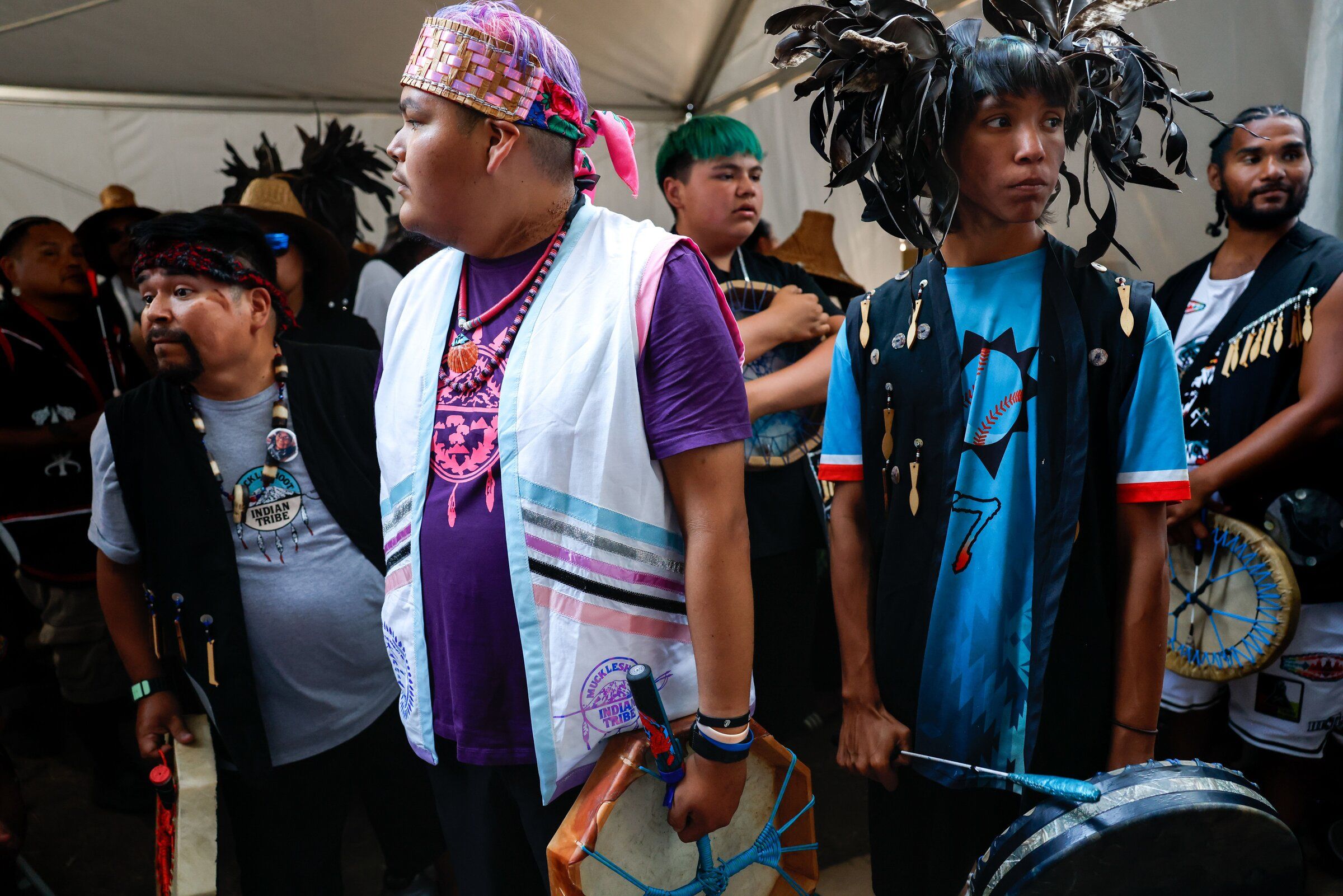 Cam Williams and Ben Anderson wait before entering the ceremonial grounds with the Muckleshoot Tribe canoe family during the 2026 Paddle to Nisqually — Medicine Creek potlatch hosted by the Nisqually Tribe on Wednesday, Aug. 5. Williams and Anderson are both members of the Muckleshoot Tribe. (Andrew Burk-Stephenson / The Seattle Times)