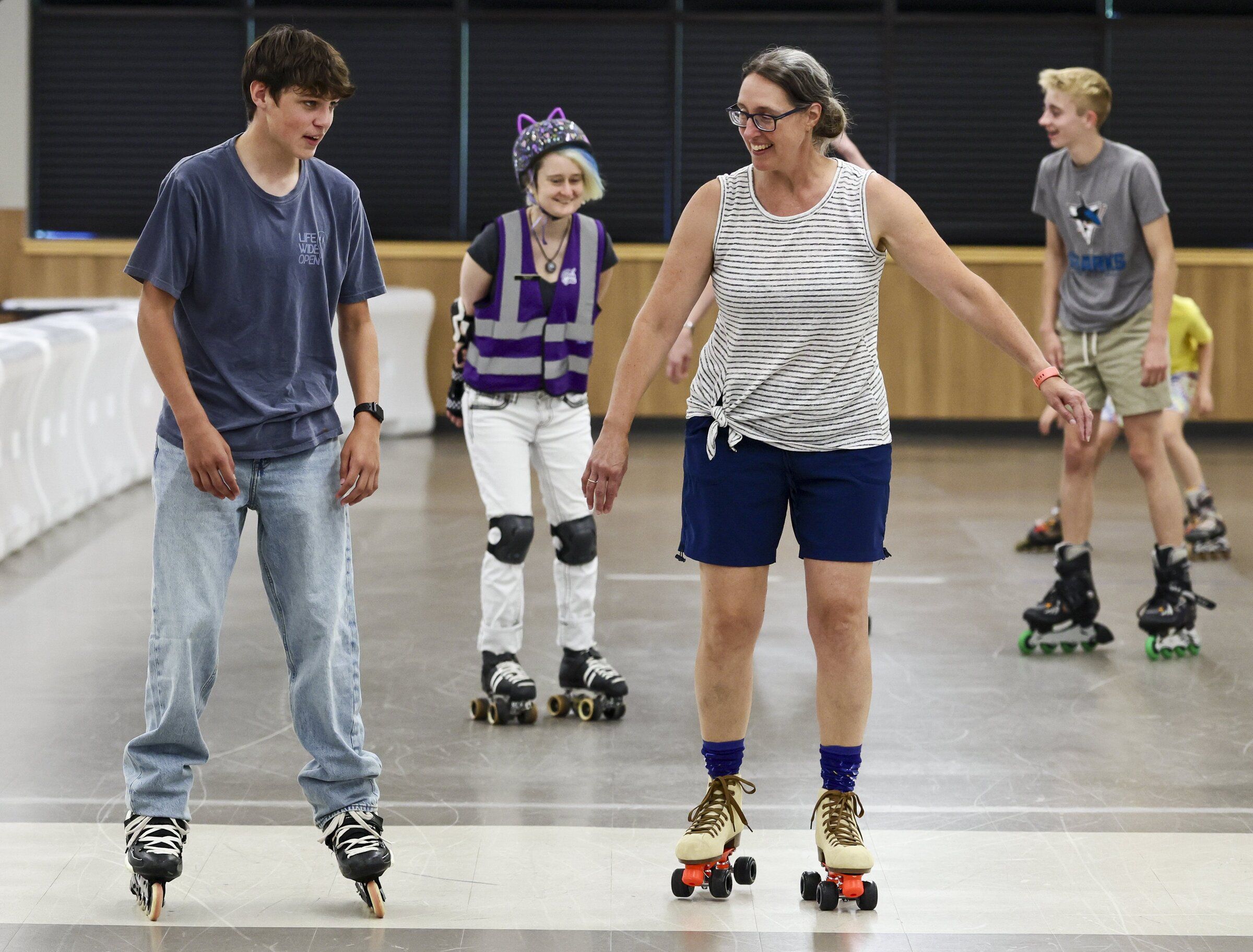 From left: Zack Ostrander, Ayla Webb, Rachel Ostrander and Warren Alexander skate around the rink Friday afternoon. (Kevin Clark / The Seattle Times)