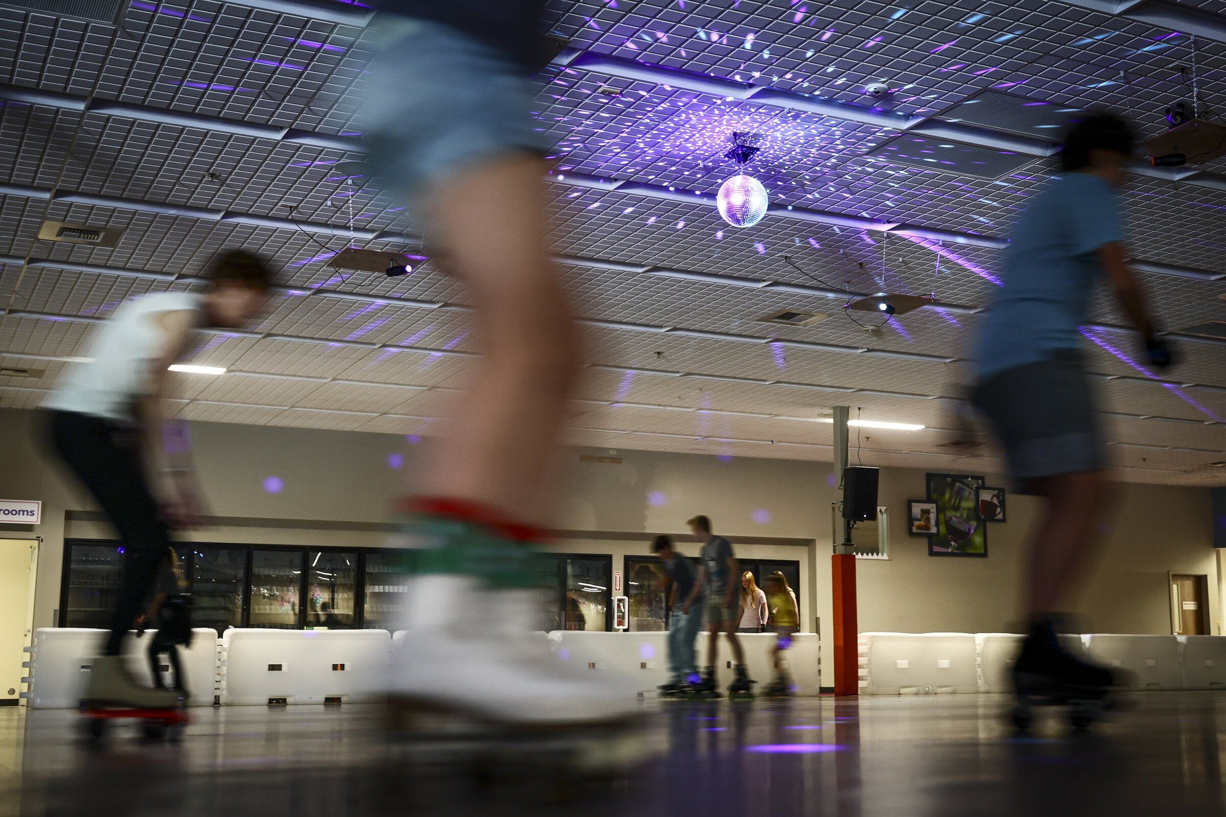 A retro disco ball adds ambience to the former drugstore retail space at Rock and Roll Roller Rink in Issaquah on Aug. 7, 2026. The nonprofit and volunteer-run rink opened last month. (Kevin Clark / The Seattle Times)
