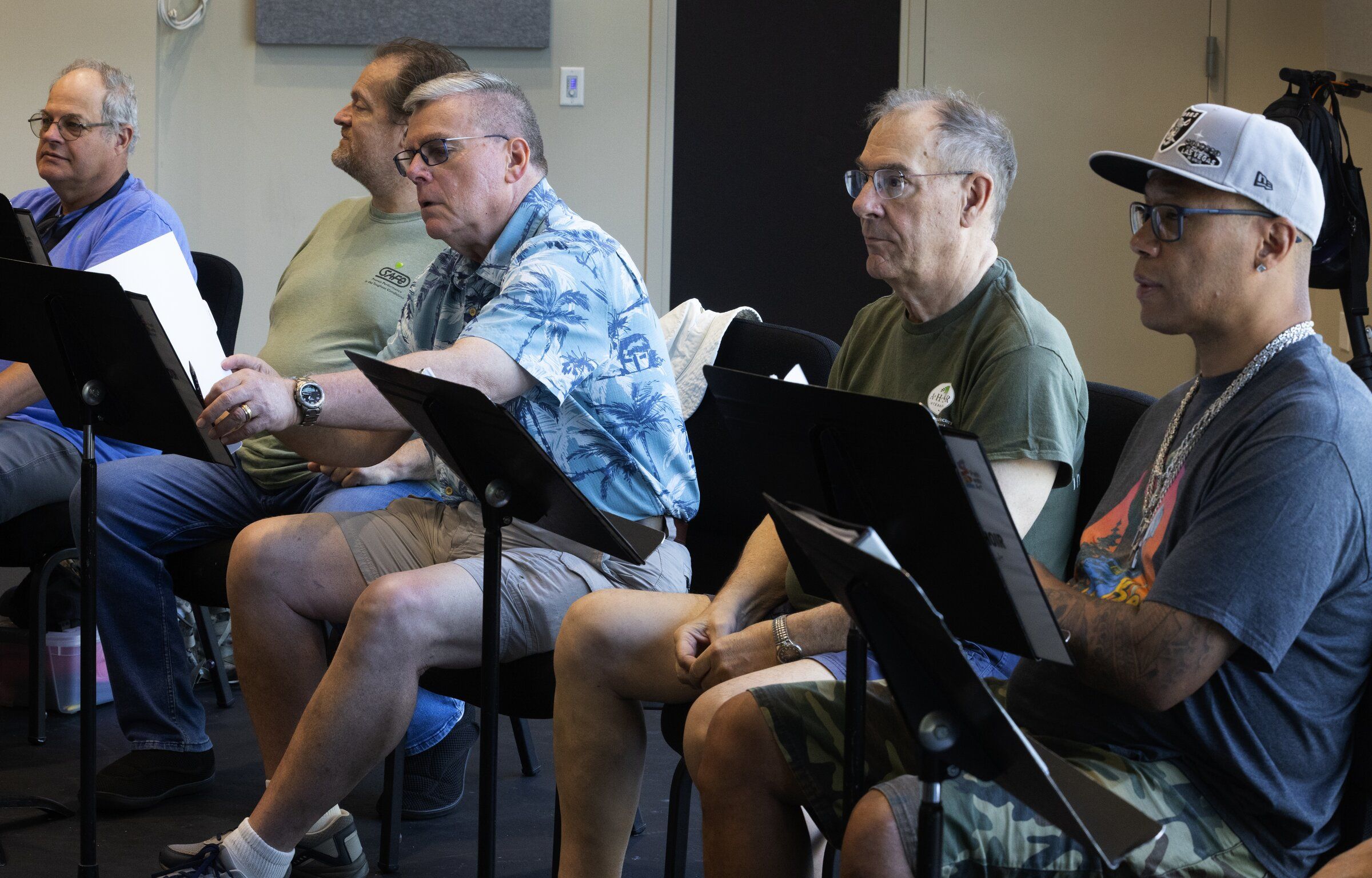 Members of the veterans choir listen during a rehearsal in Seattle on Aug. 6. (Ken Lambert / The Seattle Times)