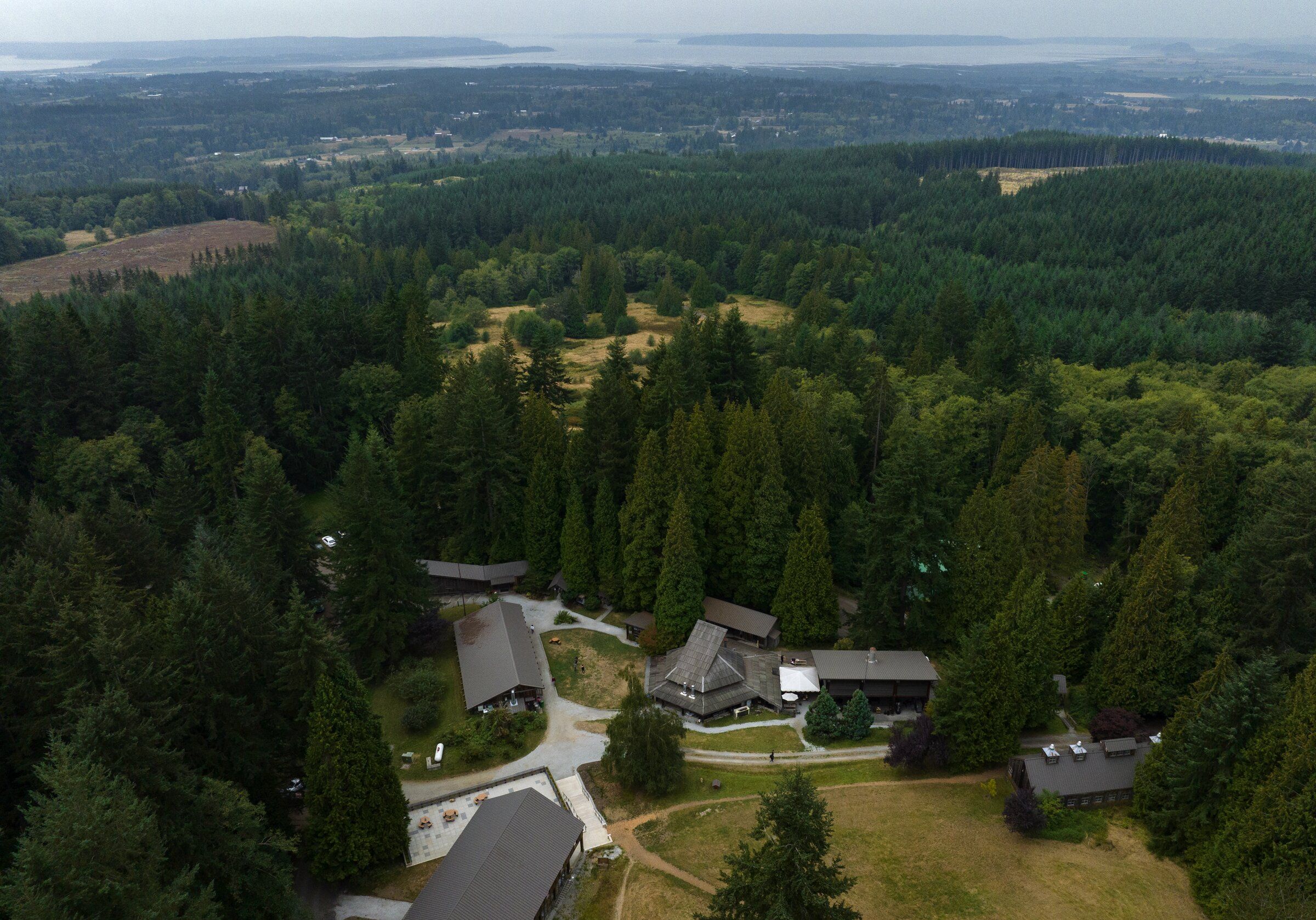 A wooded area of Stanwood, with Whidbey Island in the distance, in September 2022. (Ken Lambert / The Seattle Times)