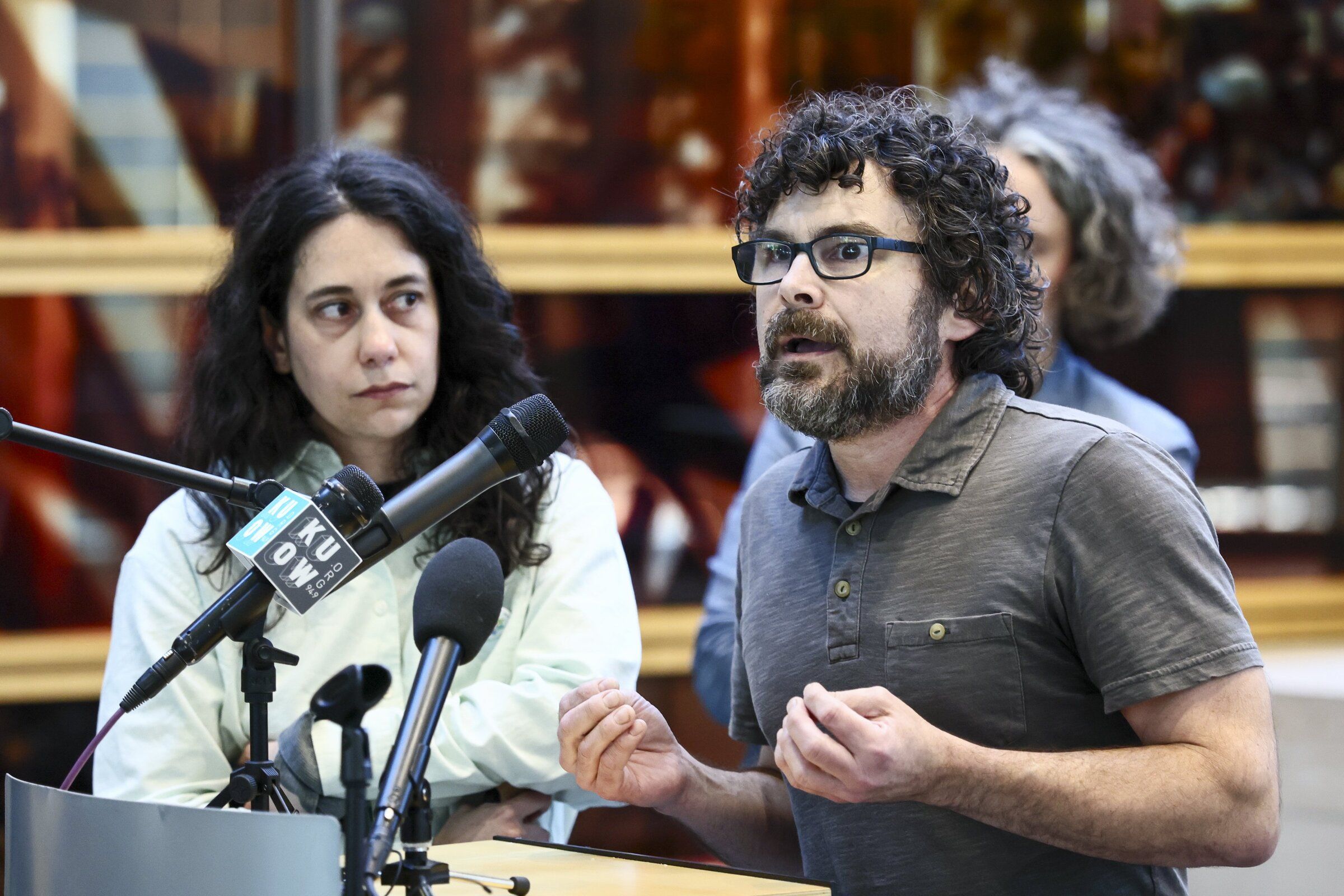 Phil Moczyk, a software engineer and civic technology specialist, right, answers a question during a news conference Monday afternoon alongside Leah Salerno of Seattle Solidarity Budget. (Kevin Clark / The Seattle Times)