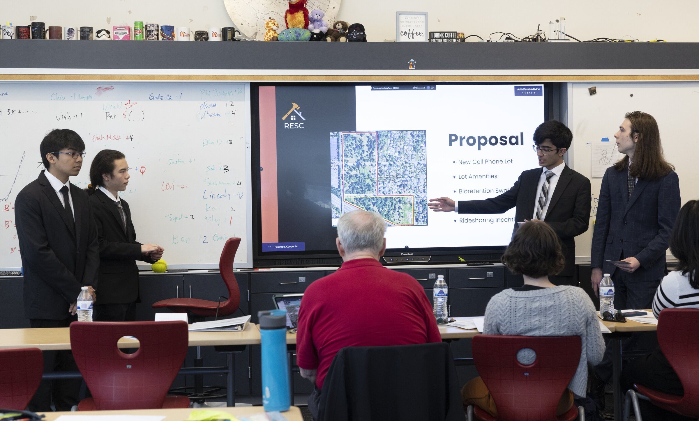 From left, Ethan Vo, Nicholas Warfield, Corey Crosby and Zafer Kilinc, all juniors at Raisbeck Aviation High School in the Tukwila, present their ideas for how the SeaTac airport can replace its crowded cell phone parking lot, in 2024. Raisbeck Aviation is ranked the 127th best high school in the nation by U.S. News & World Report. (Ellen M. Banner / The Seattle Times)