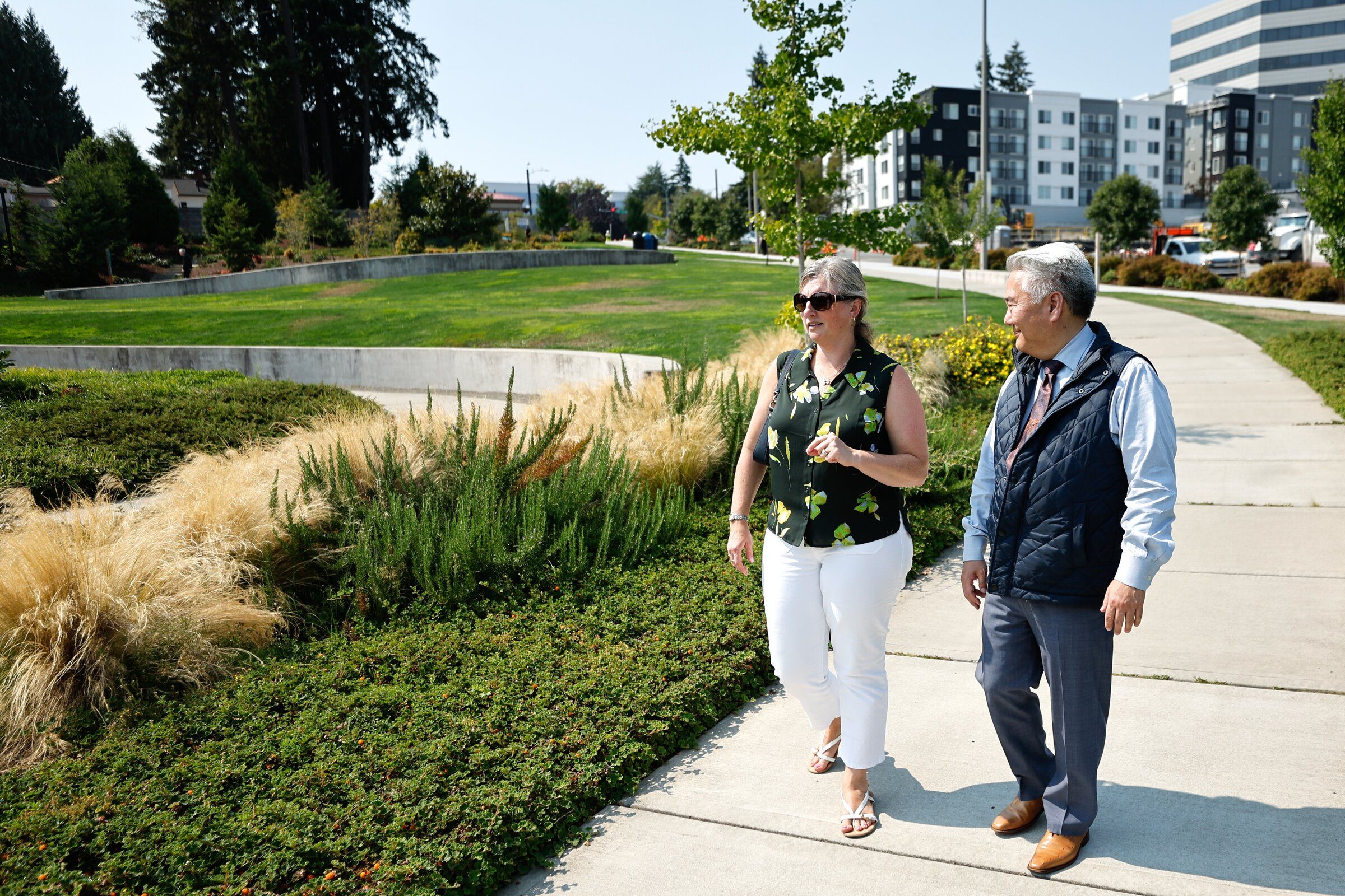 Heather Trescases, left, and Doug Ito, board members from ISAN Bellevue, visit a new downtown green space that will be called Isan Park in Bellevue. Their group is working to raise awareness about the history of Japanese Americans on the Eastside. (Karen Ducey / The Seattle Times)