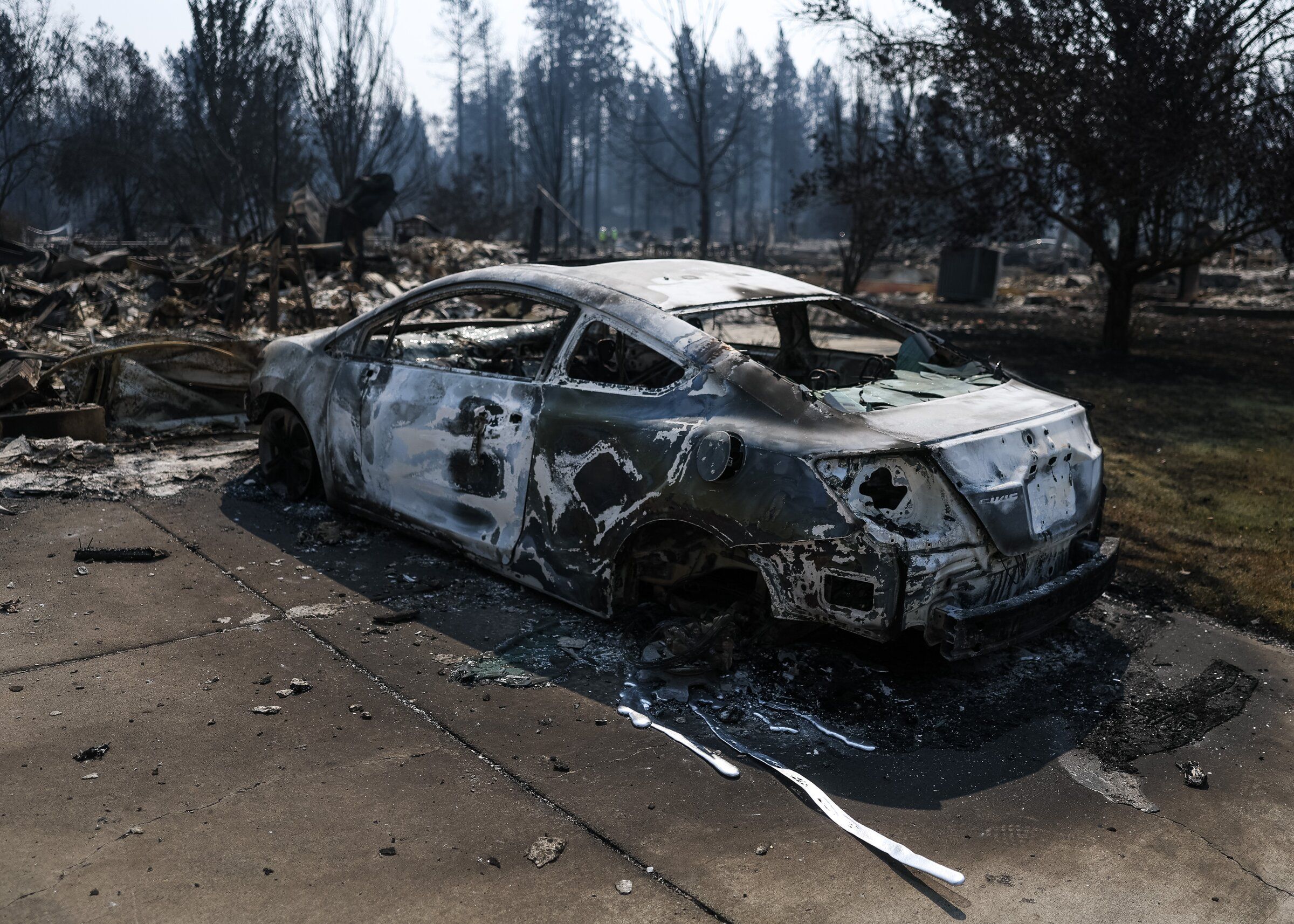 Streaks of aluminum, melted by the Old Trails fire, lie on the ground in the Rifle Club neighborhood in Spokane on Aug. 4. (Nick Wagner / The Seattle Times)