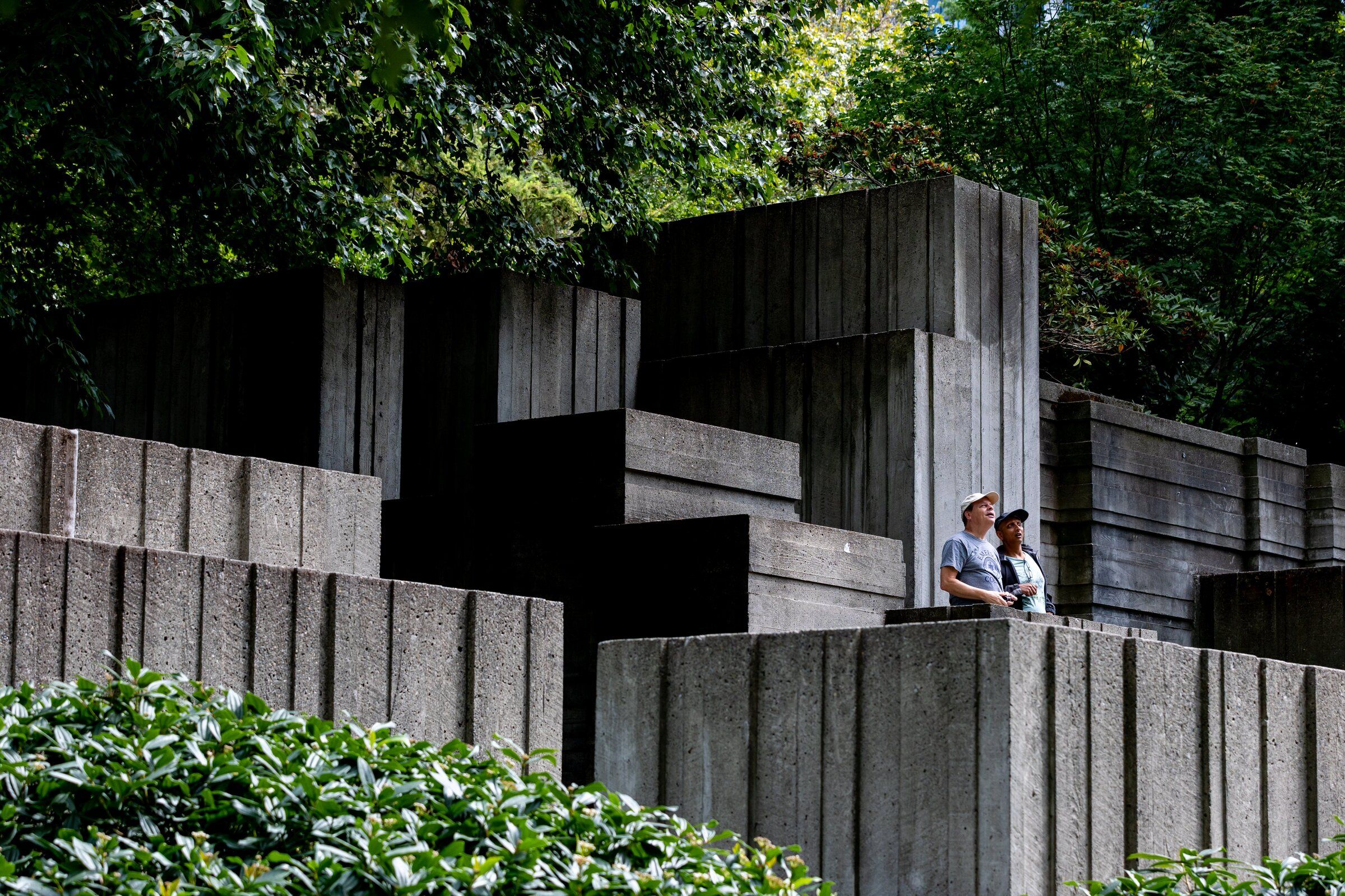 Greg Palmer, left, and Rajeev Gupta check out the scene at Freeway Park during its 50th anniversary celebration Saturday in Seattle. Palmer, who grew up in Boston, witnessed with fascination as the Big Dig transformed part of Boston and for years has been interested in Freeway Park, which was the first center-city park constructed over a freeway. (Jennifer Buchanan / The Seattle Times)