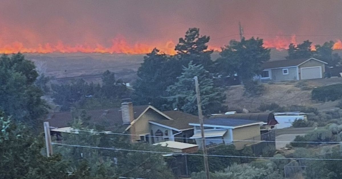 Firefighters are trying to stop a fast-moving Nevada wildfire from spreading to homes in Reno