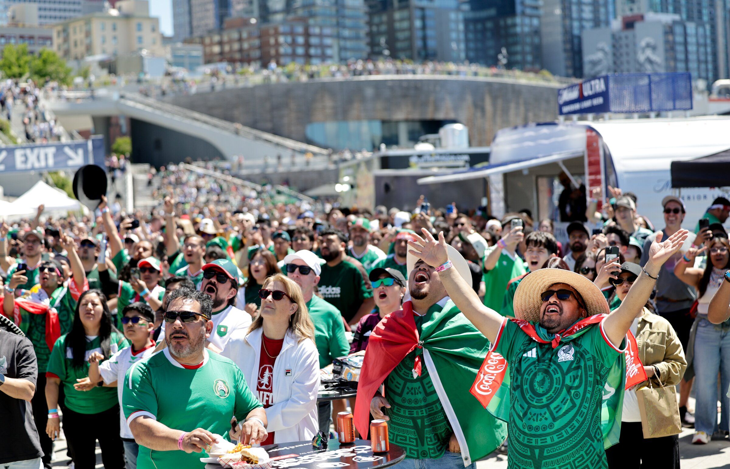 Fans cheer their teams during a watch party on Pier 62 for the FIFA Men’s World Cup match between Mexico and South Africa in Seattle, on June 10. (Karen Ducey / The Seattle Times)