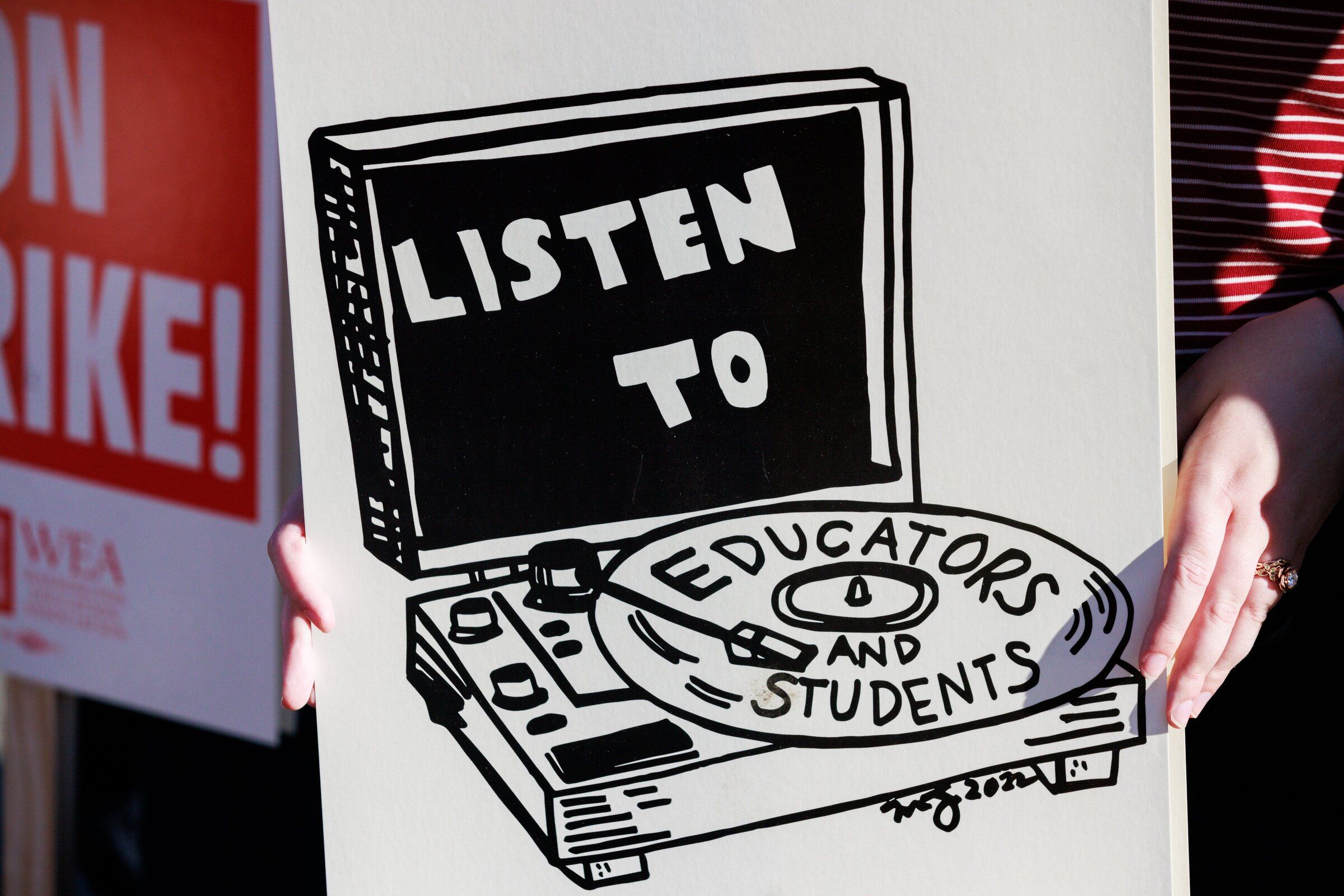 A sign supporting Seattle educators and students is seen at a rally hosted by the Seattle Education Association outside Seattle Public Schools’ headquarters in Sodo in September 2022, the last time Seattle teachers went on strike. (Erika Schultz / The Seattle Times)