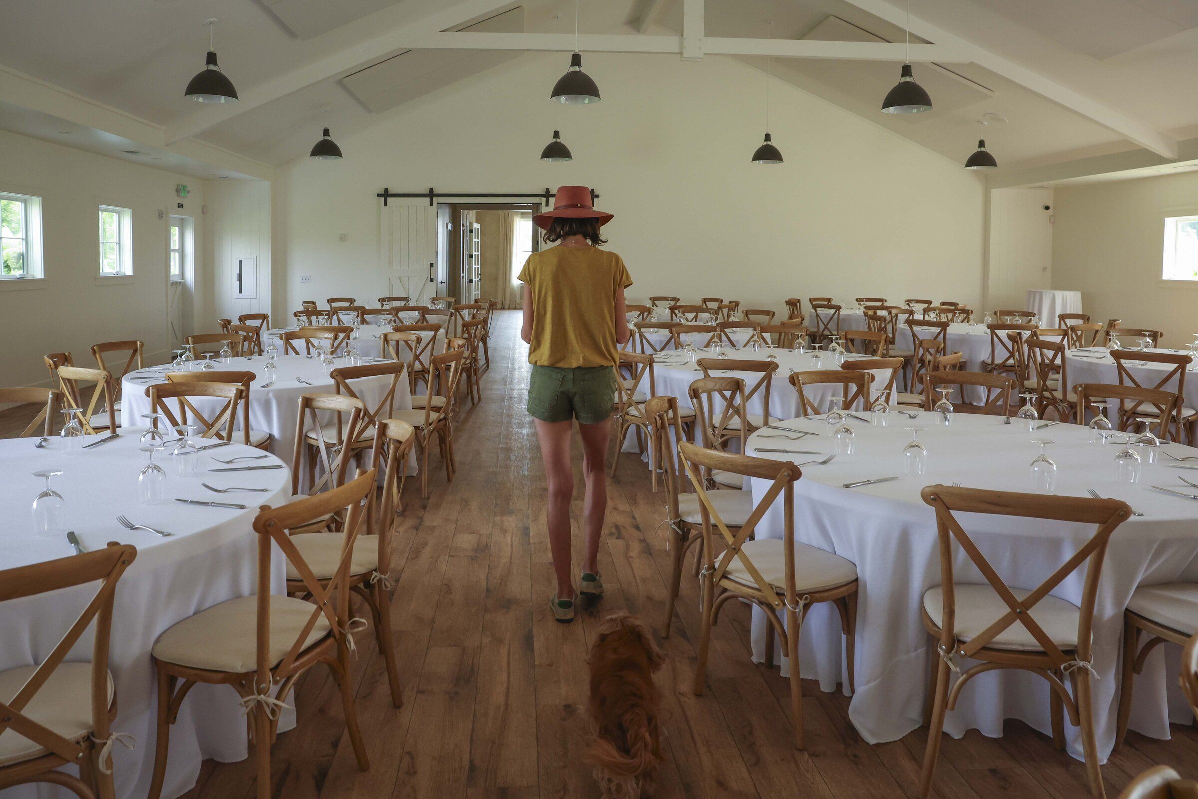 Co-owner Jacquelyn Jaech walks to her office at Harmony Meadows Tennis Resort’s event hall in Manson on Thursday, Aug 20. Jaech said a normally busy wedding season is down to one wedding booked for next month if her clients do not cancel due to the wildfire. (Ivy Ceballo / The Seattle Times)