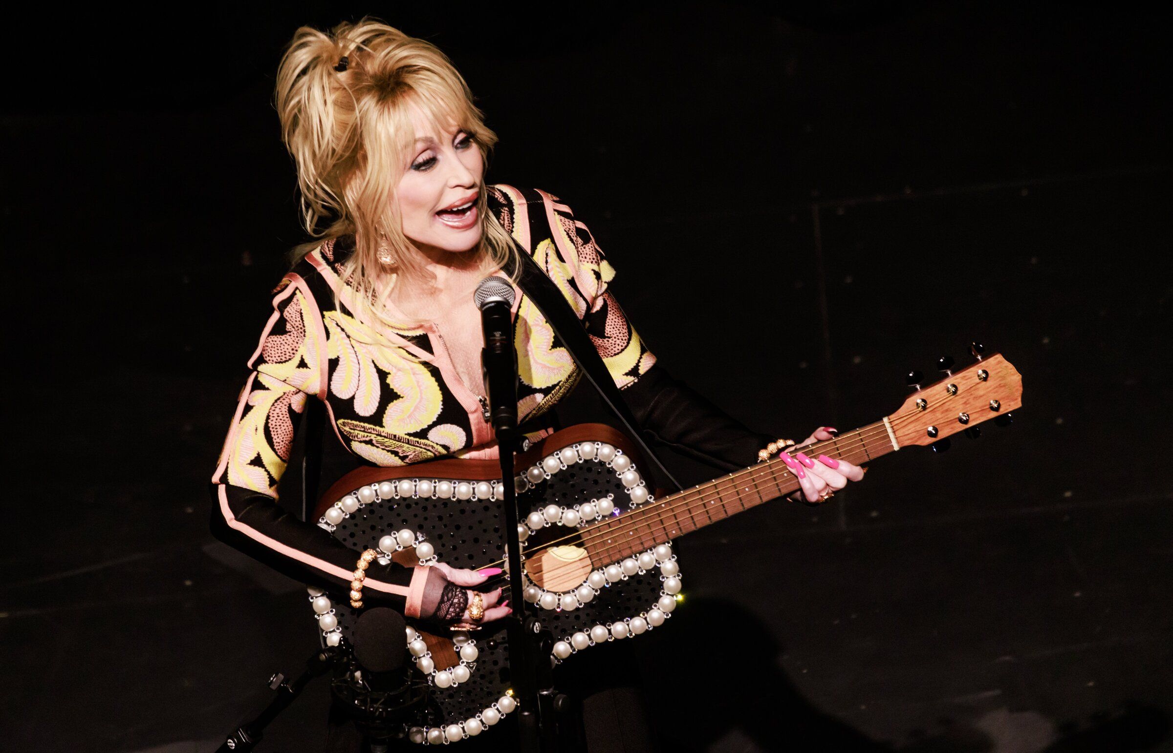 Dolly Parton performs at a celebration for the Imagination Library at the Pantages Theater in Tacoma in 2023. (Erika Schultz / The Seattle Times)