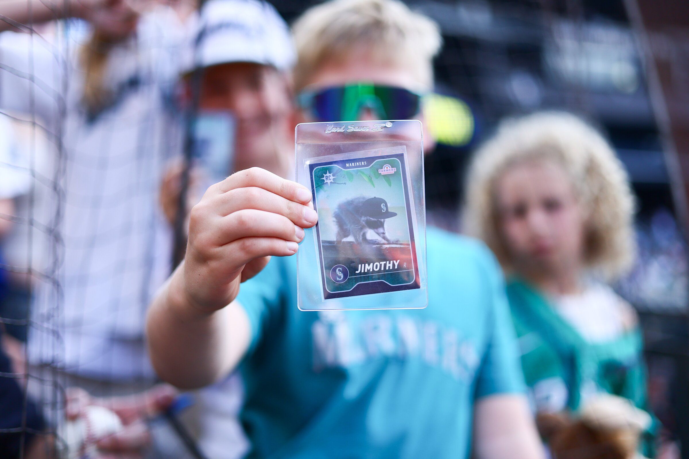 A Mariners fan poses with a Jimothy card before a game between the Seattle Mariners and Detroit Tigers on Aug. 5. (Kevin Ng / The Associated Press)