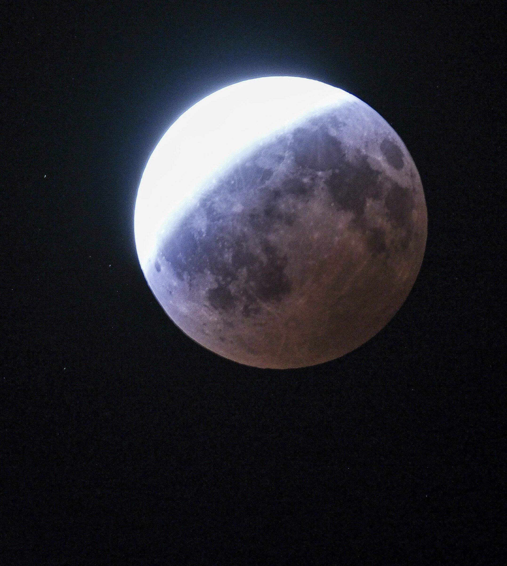The moon during a partial eclipse, visible from Lake Forest Park on Thursday. (Dean Rutz / The Seattle Times)