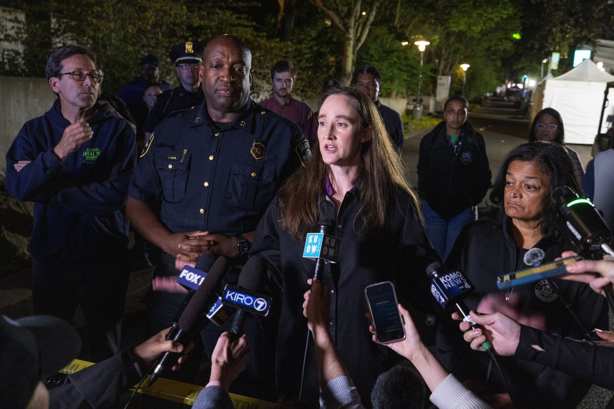 From left, Washington Gov. Bob Ferguson, Seattle police Assistant Chief Tyrone Davis, Seattle Mayor Katie Wilson, speaking, and U.S. Rep. Pramila Jayapal appear together at a news conference at Seattle Center after the July 26 mass shooting there. (Ken Lambert / The Seattle Times)