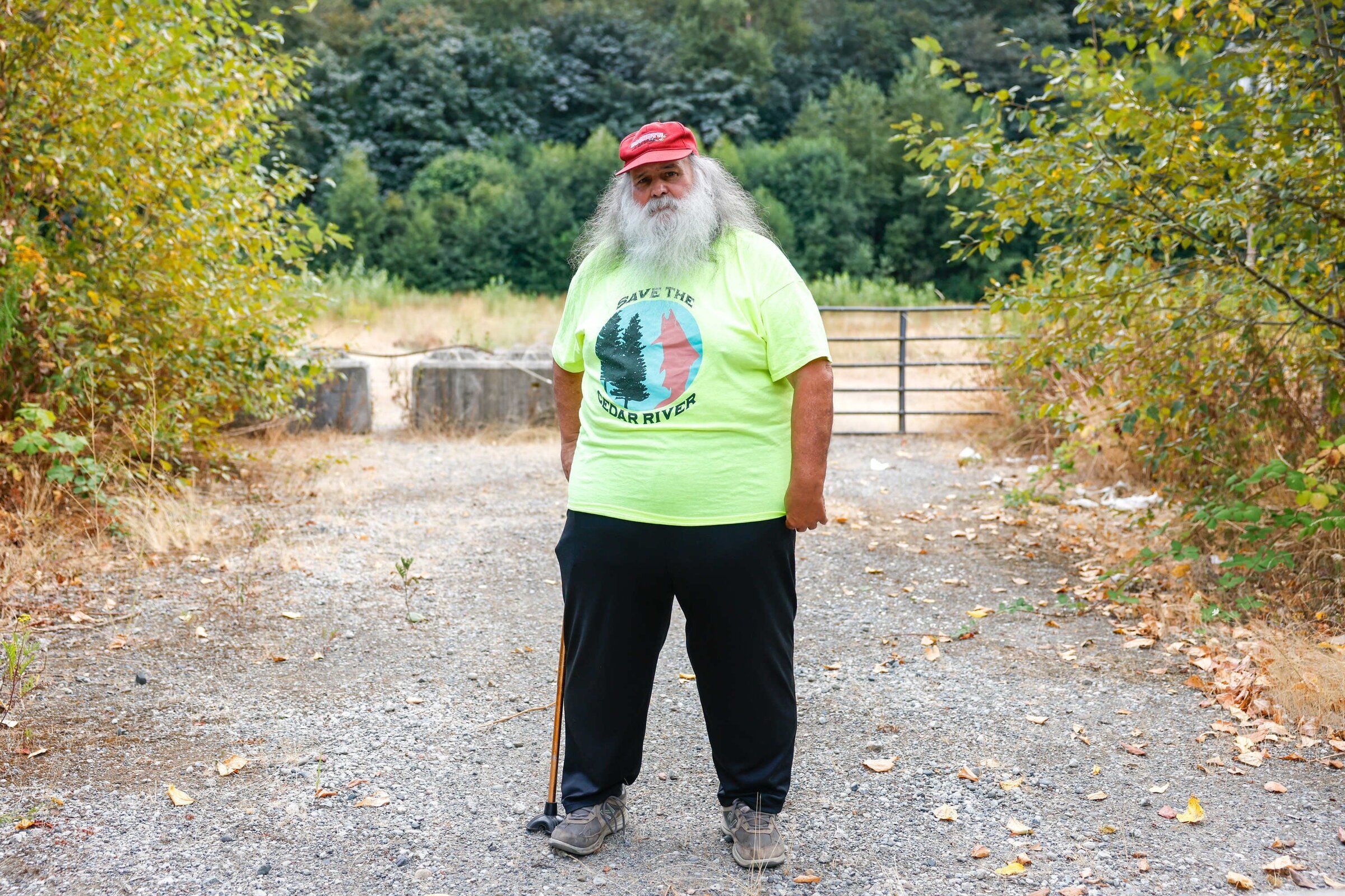Bob Baker, wearing a T-shirt bearing the name of his Save the Cedar River protest group, recalls their approach as doing “whatever we could to delay, and they finally just said, ‘we’re done,'” (Andrew Burke-Stevenson / The Seattle Times)