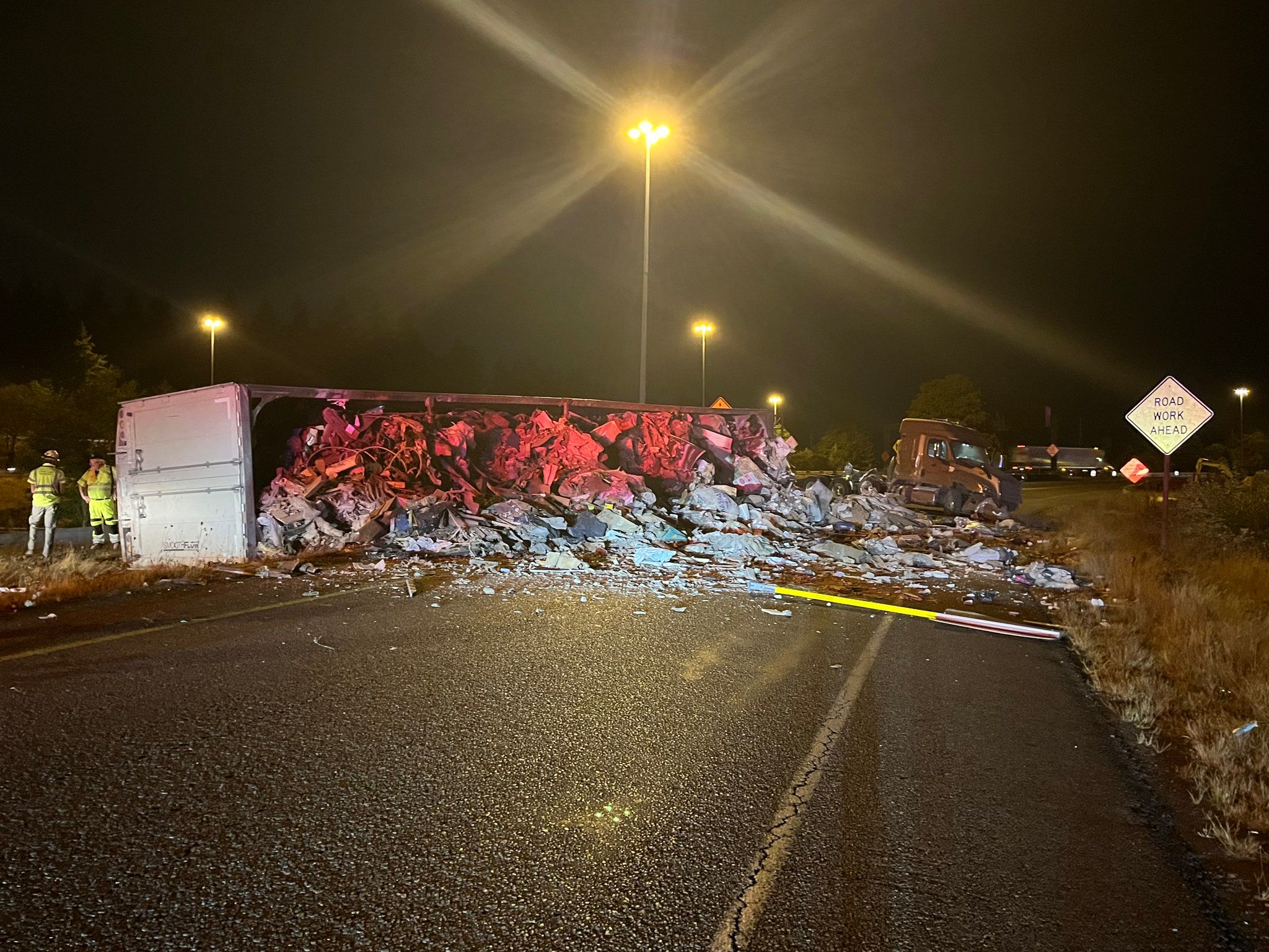 An overturned semitruck and trash block the ramp from northbound Interstate 405 to eastbound Interstate 90 on Thursday. (Washington State Patrol)