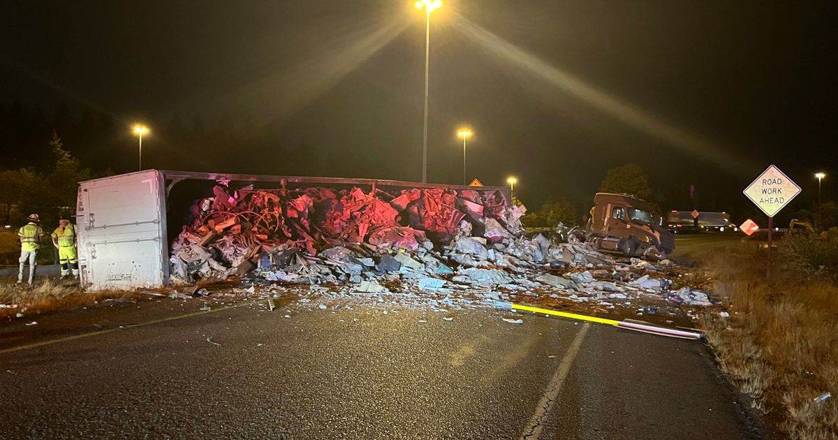 I-405 ramp to I-90 blocked after semitruck flips, spills garbage