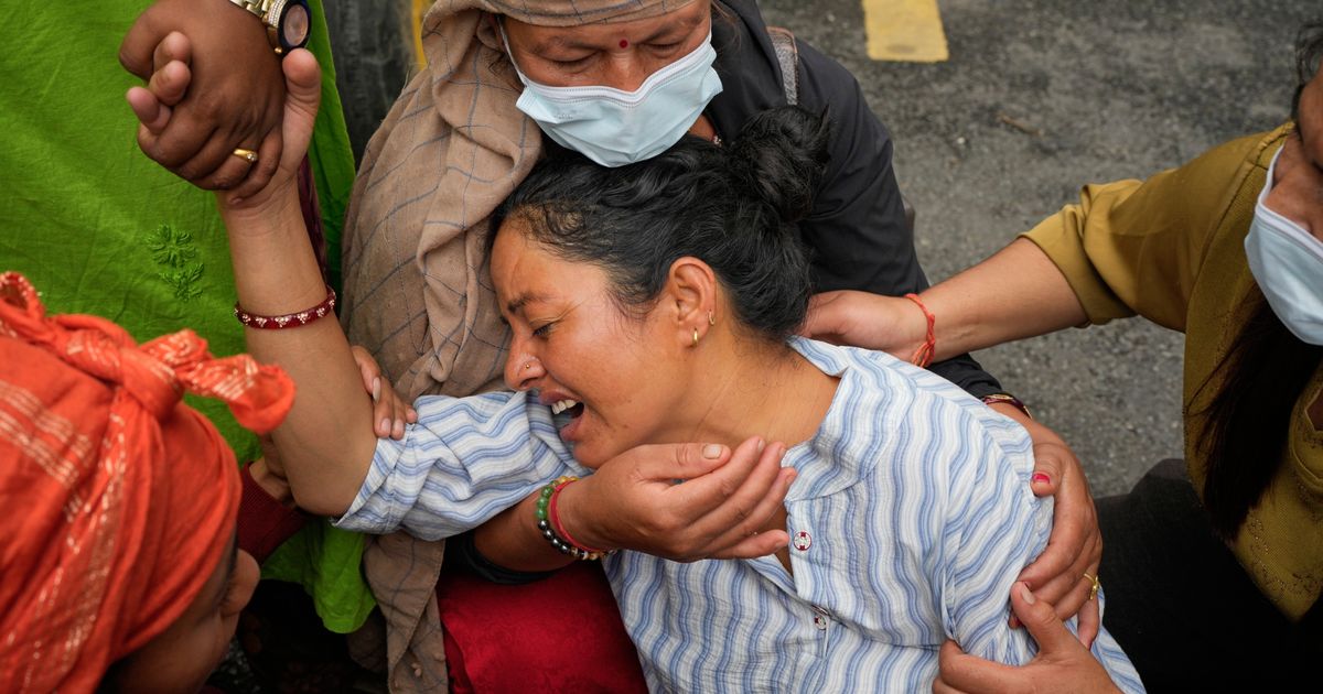 Photos show a family in Nepal bid farewell, as other flood victims are buried in unmarked graves