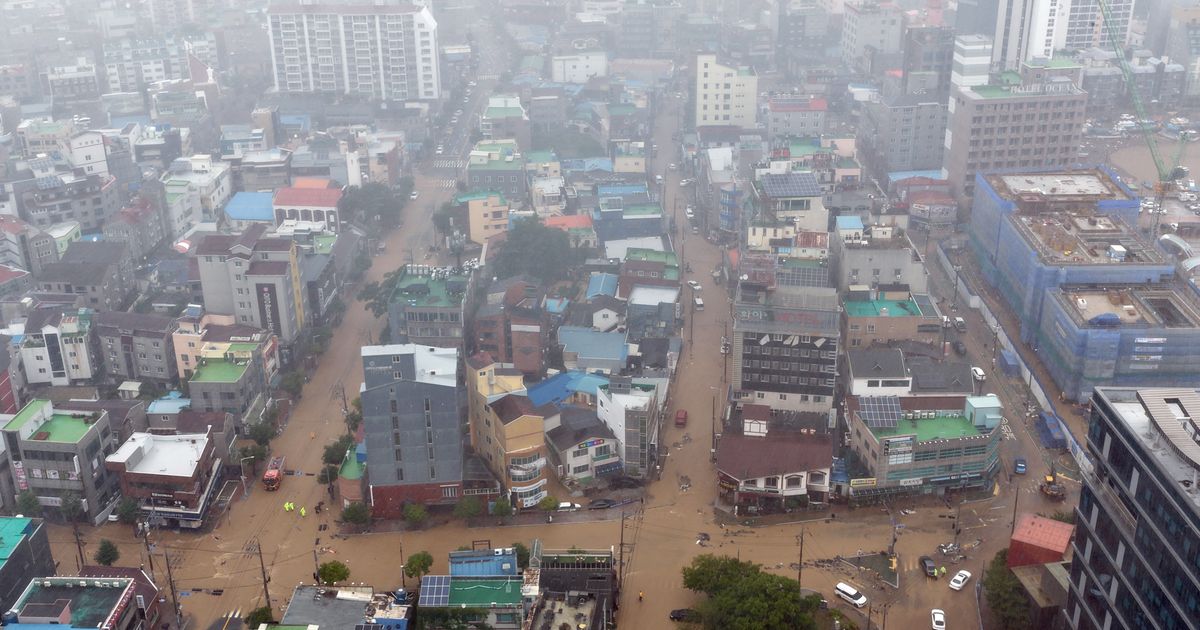 Heavy rains kill 1 in South Korea and flood major streets in Philippines