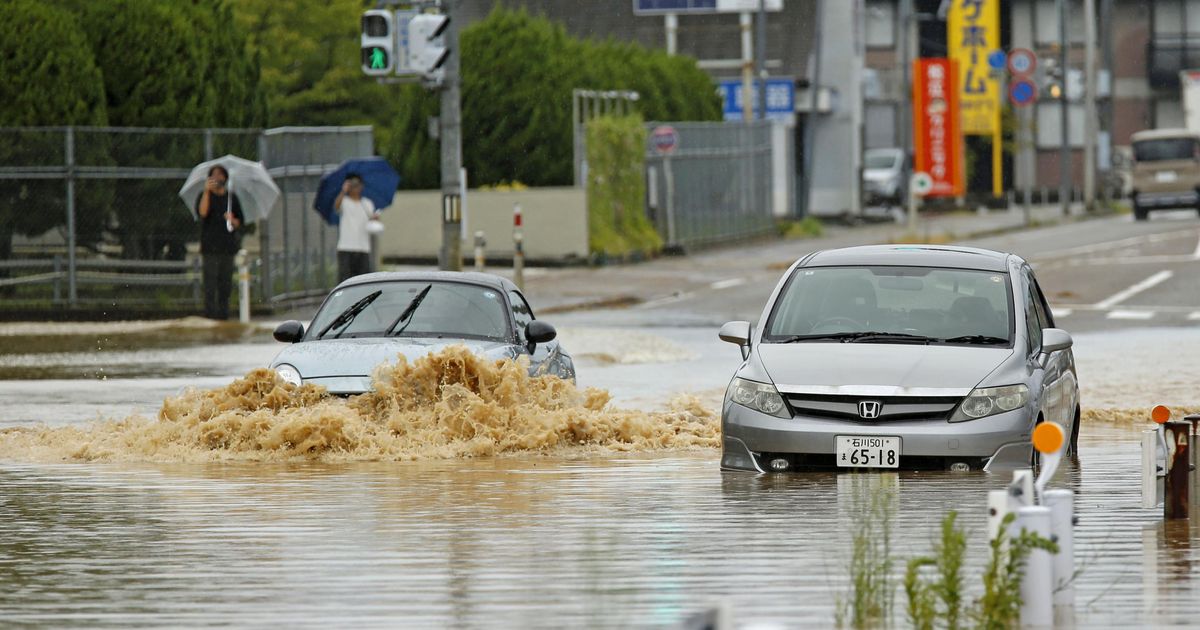 Heavy rain and flooding in north-central Japan strands people and vehicles