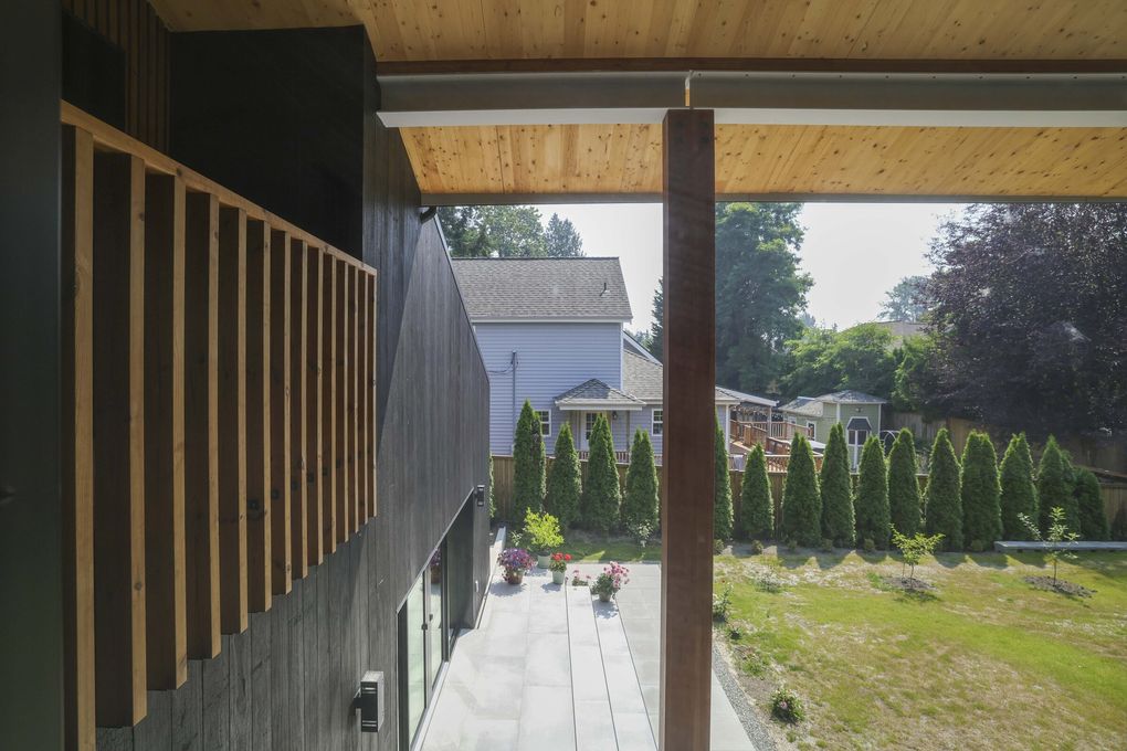 The greenery outside seems to blend with the Kenmore house’s engineered wood. (Ivy Ceballo / The Seattle Times)