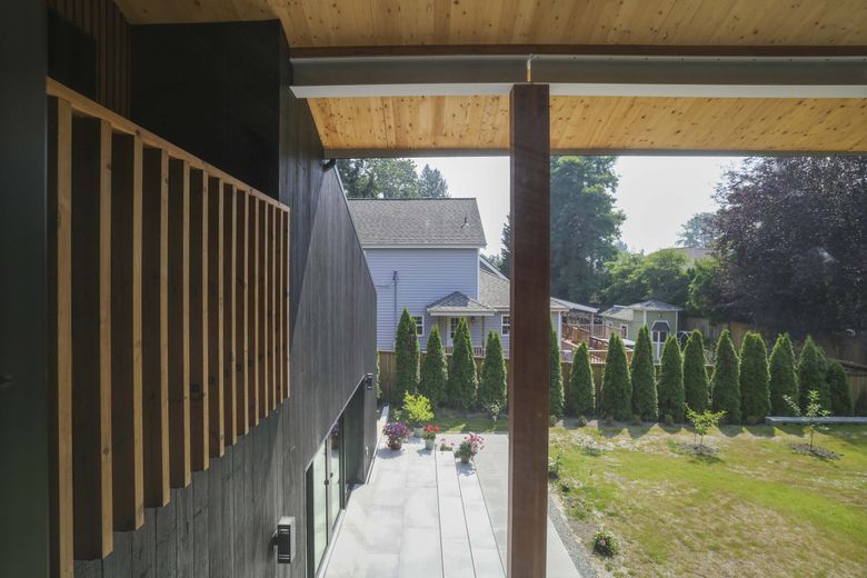 The greenery outside seems to blend with the Kenmore house’s engineered wood. (Ivy Ceballo / The Seattle Times)