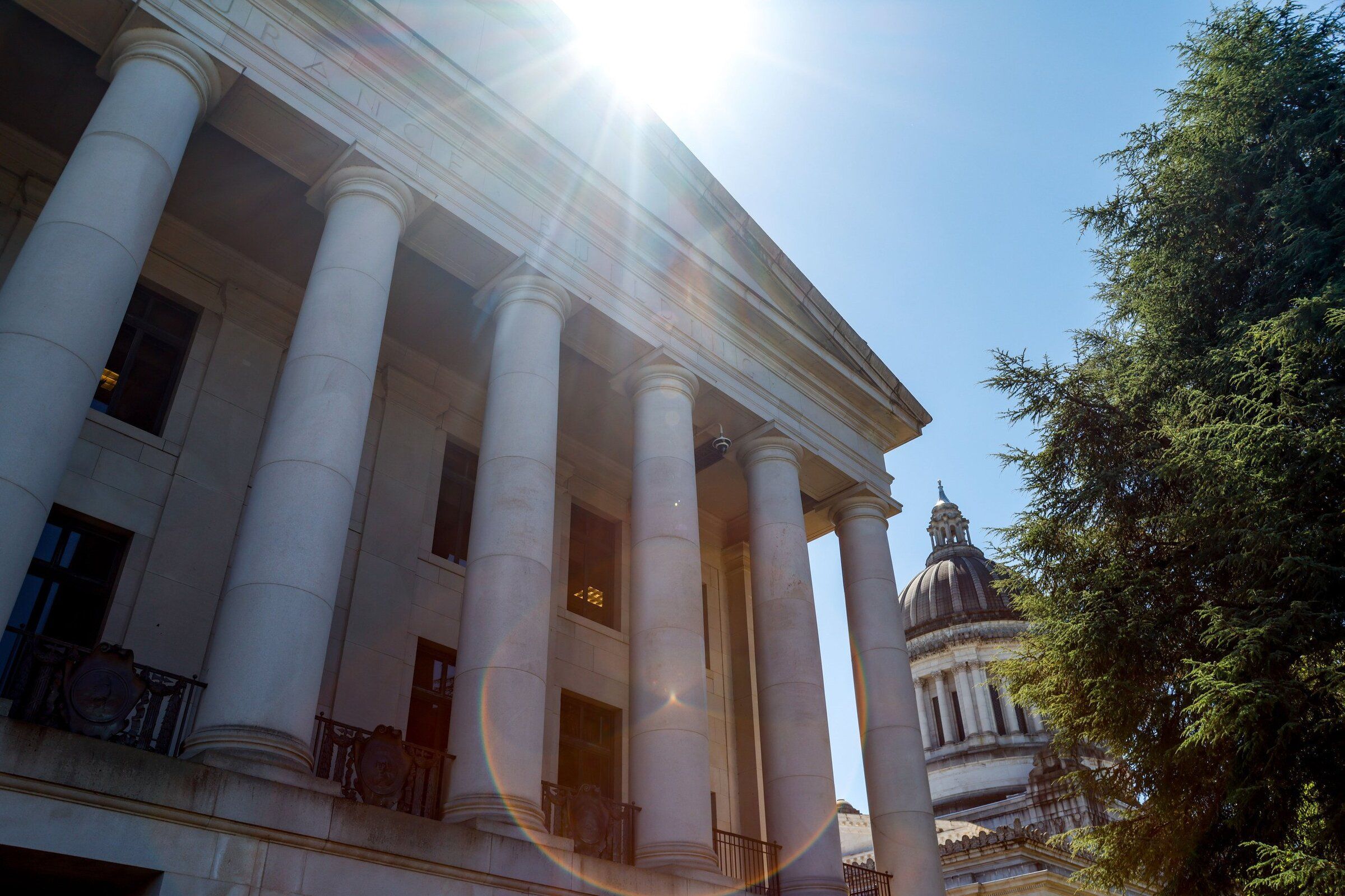 The Legislative Building, right, seen past the Insurance Building on the Washington State Capitol Campus in Olympia, on July 9. (Andrew Burke-Stevenson / The Seattle Times)