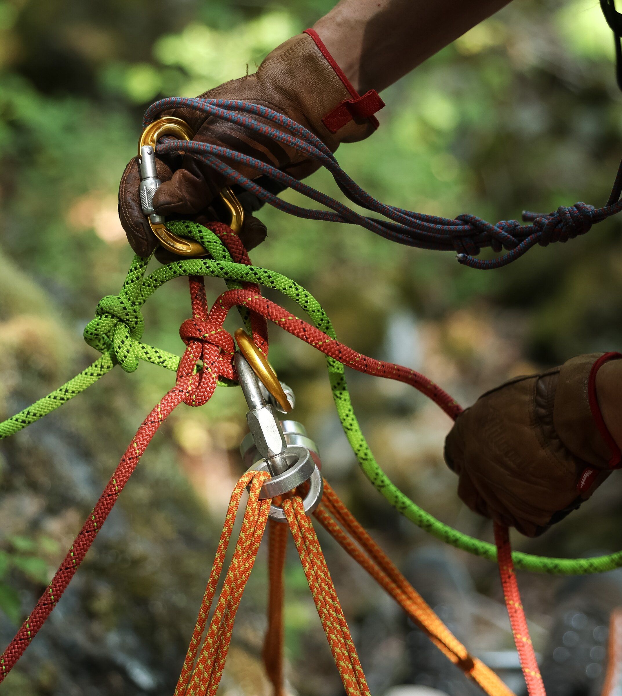 Jeremy Heater, a team leader with King County Explorer Search & Rescue, manages the rope lines attached to a litter during training in July near North Bend. (Nick Wagner / The Seattle Times)