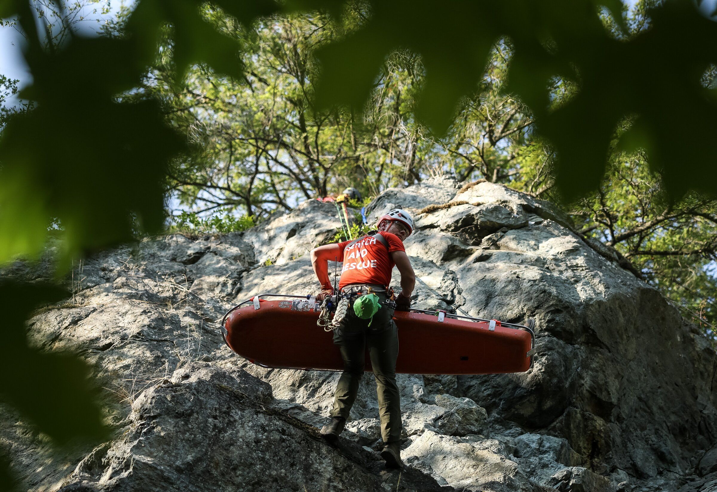 Jeremy Heater, a team leader with King County Explorer Search & Rescue, climbs a rock face with a litter during training near North Bend. (Nick Wagner / The Seattle Times)