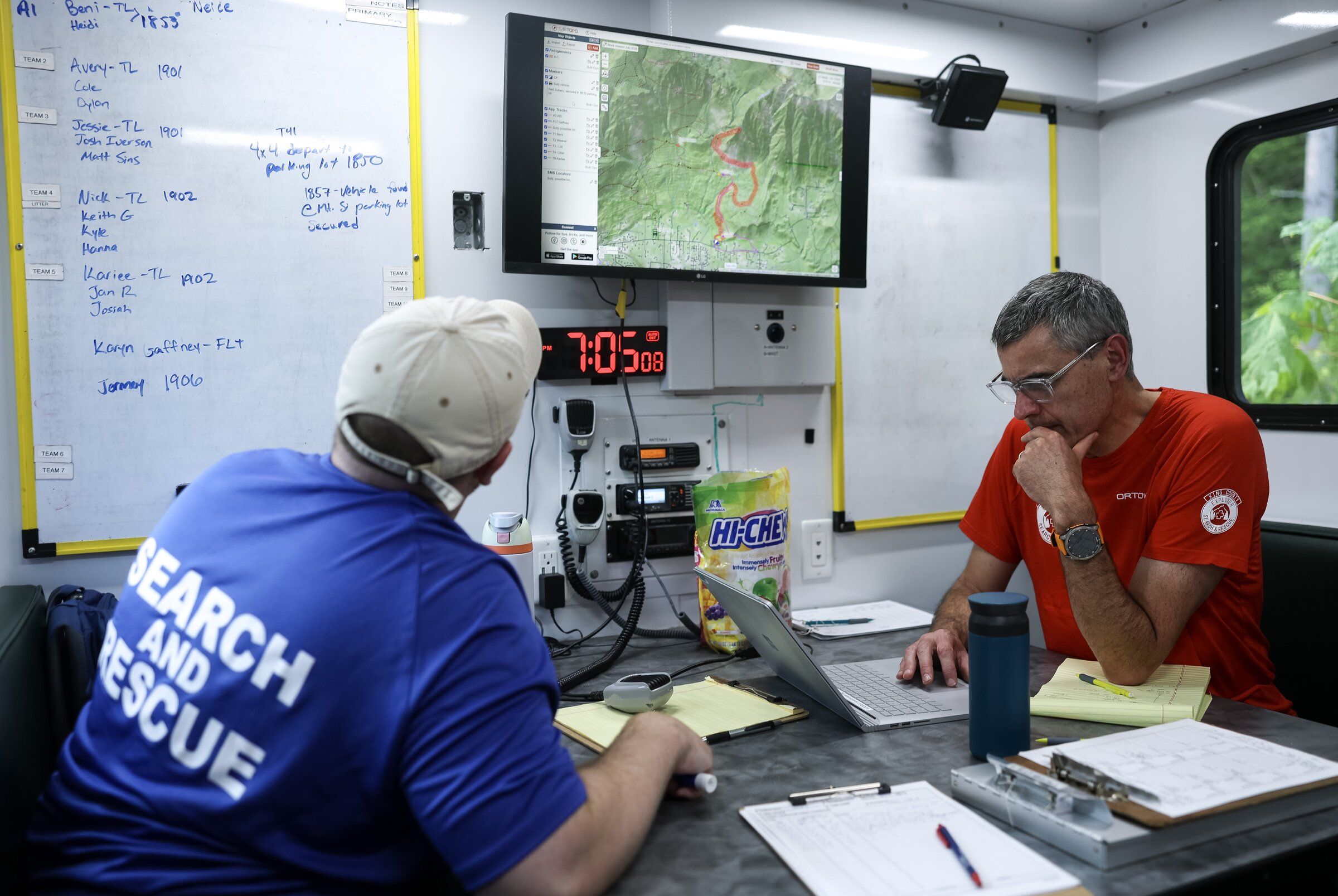King County Search and Rescue field leader Jai Devant (right) and operations support team member Sean Walker monitor the incident map during a training exercise near North Bend. (Nick Wagner / The Seattle Times)