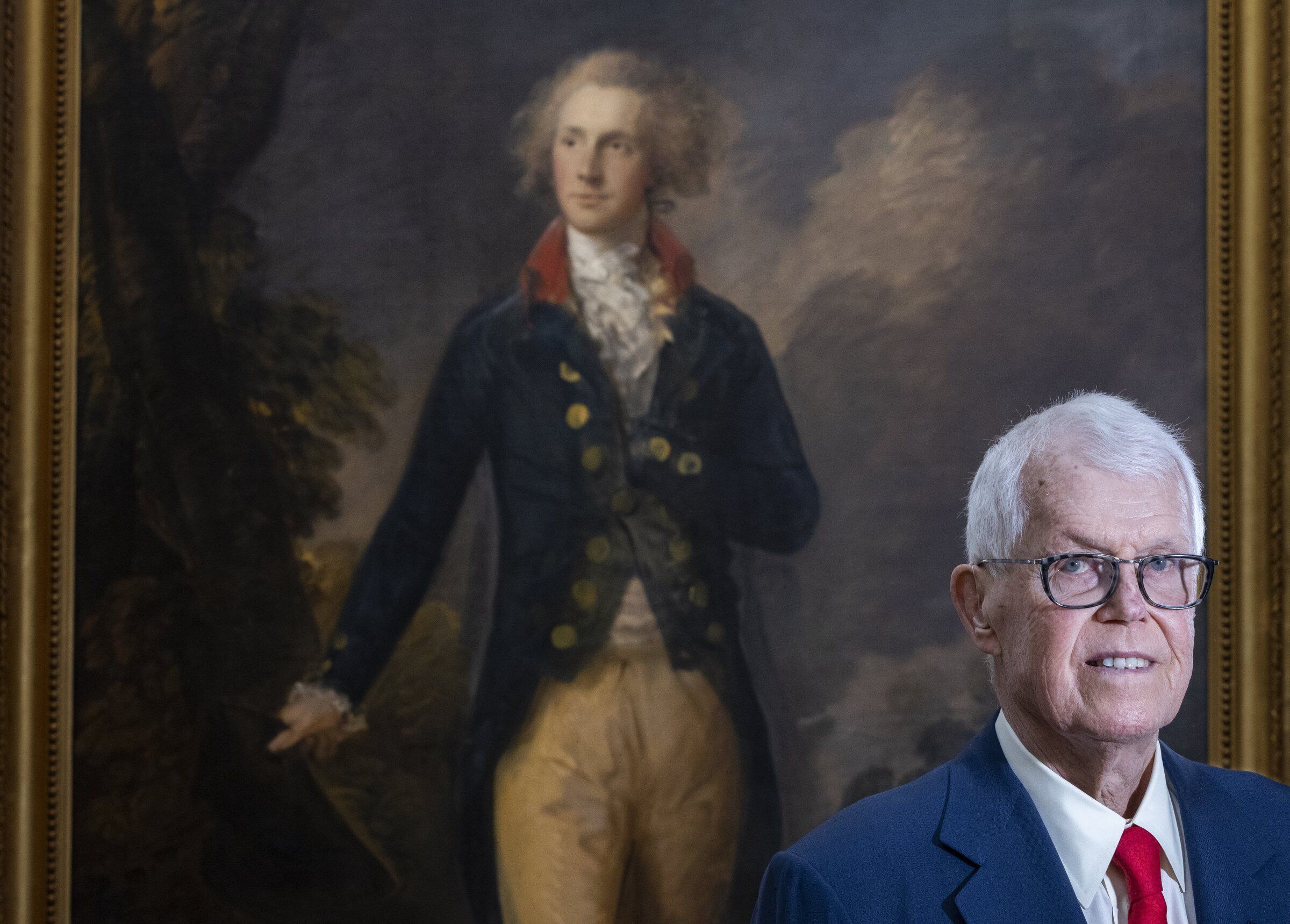 Businessman and art collector Richard “Dick” Hedreen is donating millions of dollars’ worth of artwork to Seattle University. Some of the works will go up for auction in November. He stands in front of one of the pieces he is donating, Thomas Gainsborough’s 18th-century painting “Henry Beaufoy, Member of Parliament.” (Ellen M. Banner / The Seattle Times, 2024)