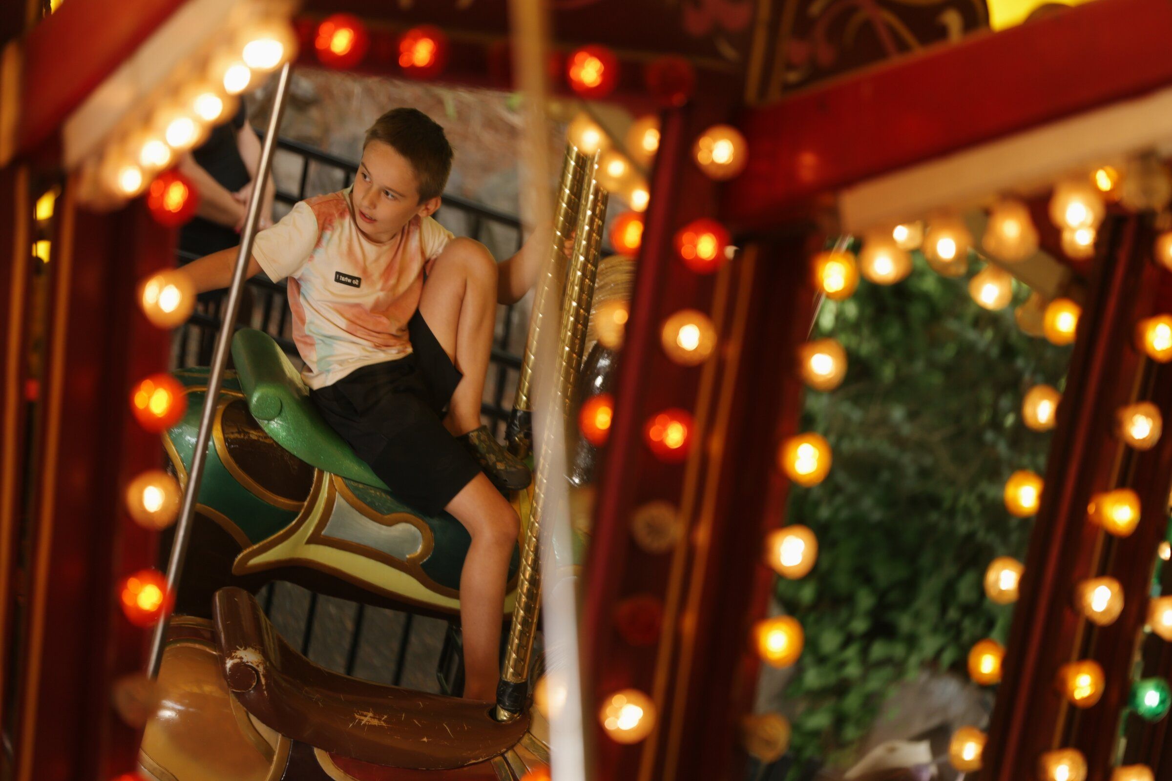 A rider is reflected in the mirrors of the carousel, built in 1906, at Wild Waves on Aug. 29. (Genna Martin / special to The Seattle Times)