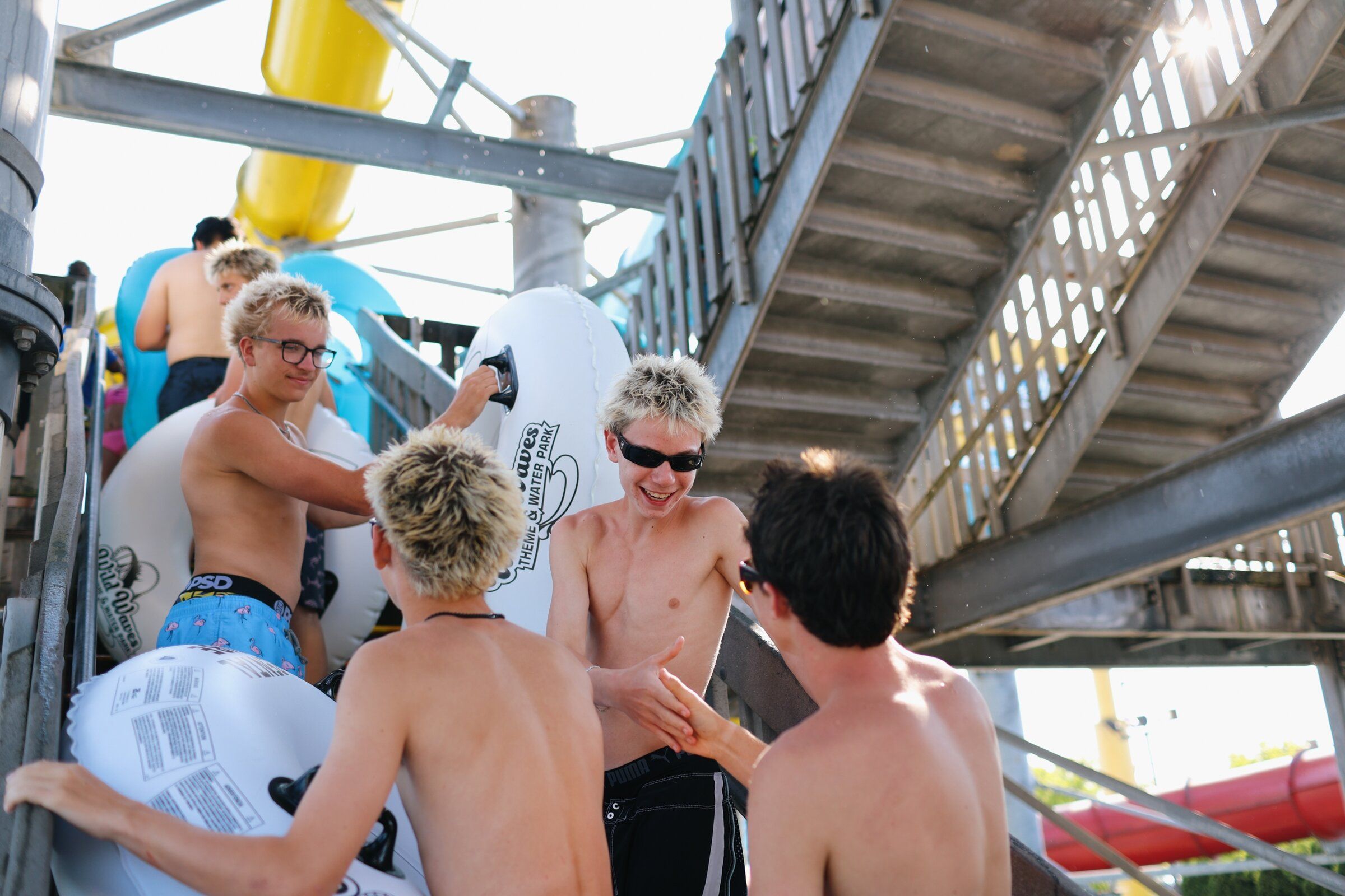 Friends from Camas in Clark County, including Sally Crook, left, AJ Hibler, Josh Weinstock and Cody Cannone, wait in line for the Konga Slides at Wild Waves on Aug. 18. (Genna Martin / special to The Seattle Times)