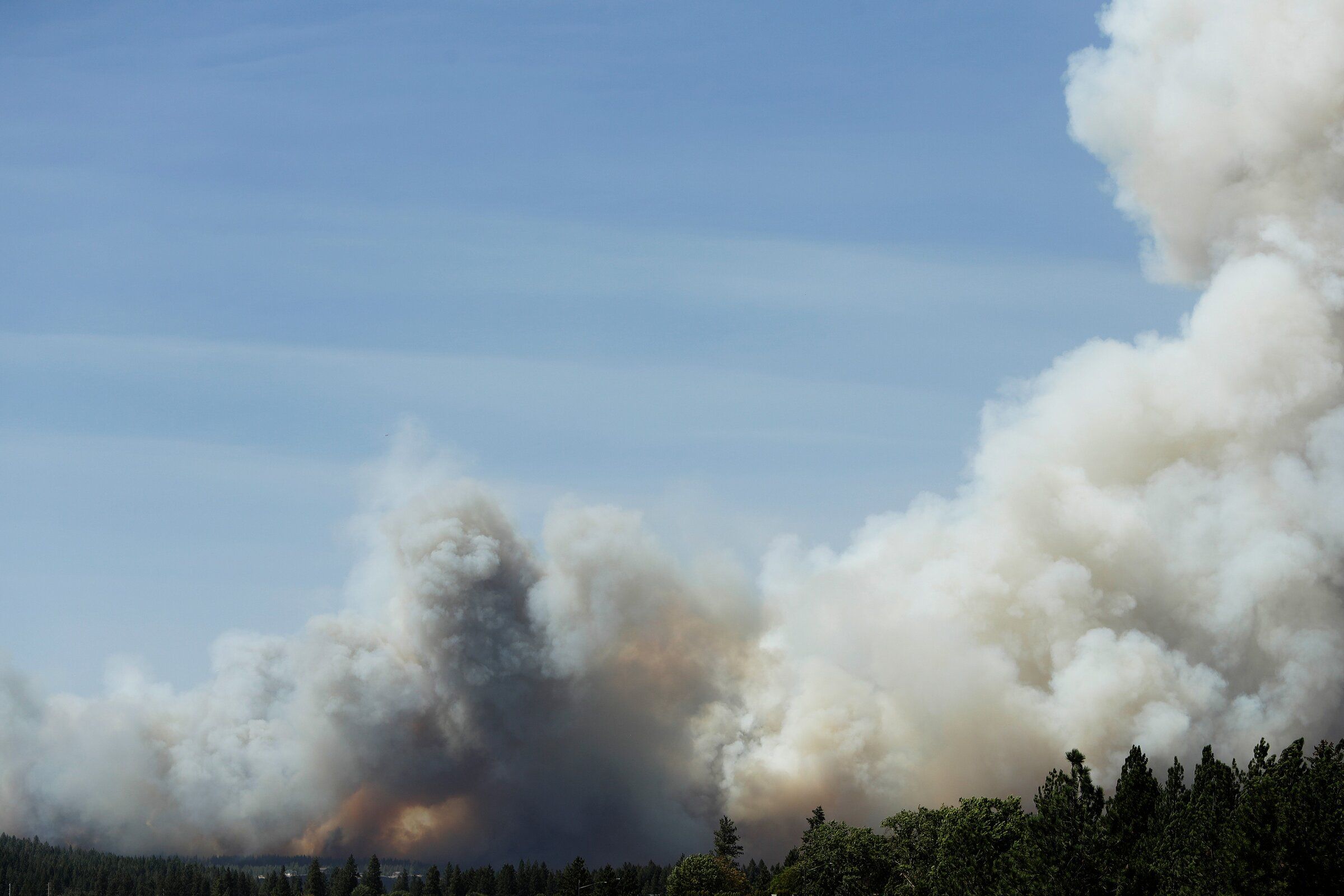 The Old Trails fire is seen from the Centennial Trail near West College Avenue in Spokane last month. (Ian Quak / The Associated Press)