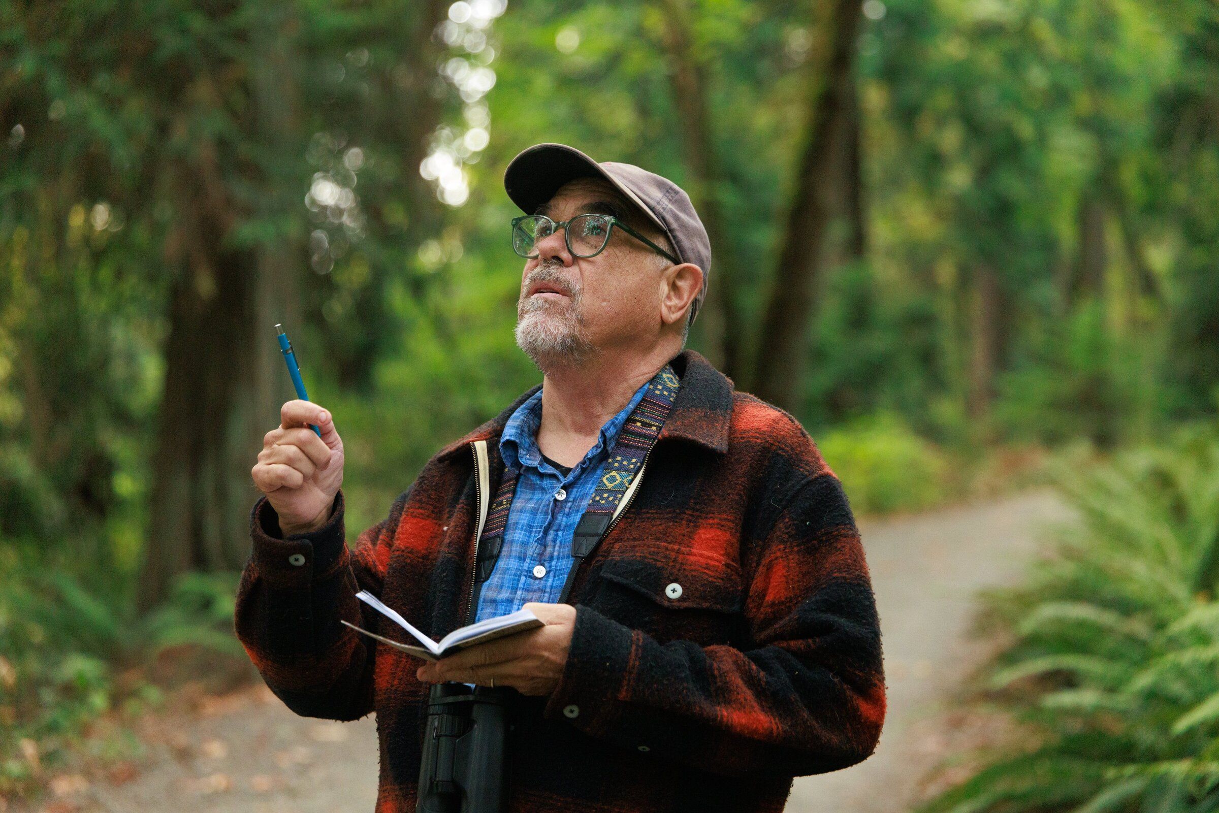 Michael Witter, a retired biologist, conducts a bird survey as part of the Neighborhood Bird Project at Seward Park in Seattle on Sept. 12. Once a month, volunteers track bird species diversity throughout Seattle’s city parks and green spaces. (Erika Schultz / The Seattle Times)